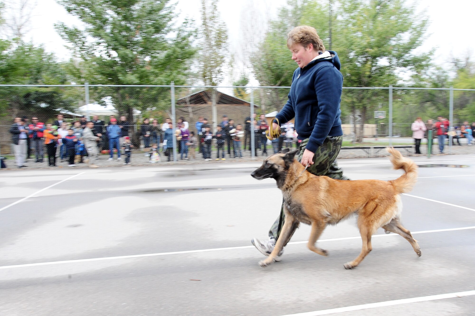 Kyrgyzstan State Security Service K-9 Unit Chief Maj. Natalia Balabrikova displays techniques with her dog, Volia, for an audience during Friends and Family Day Oct. 9, 2009, at the Transit Center at Manas, Kyrgyzstan. The event strengthened friendships between the U.S. military and the local community. (U.S. Air Force photo/Senior Airman Steele C. G. Britton) 
