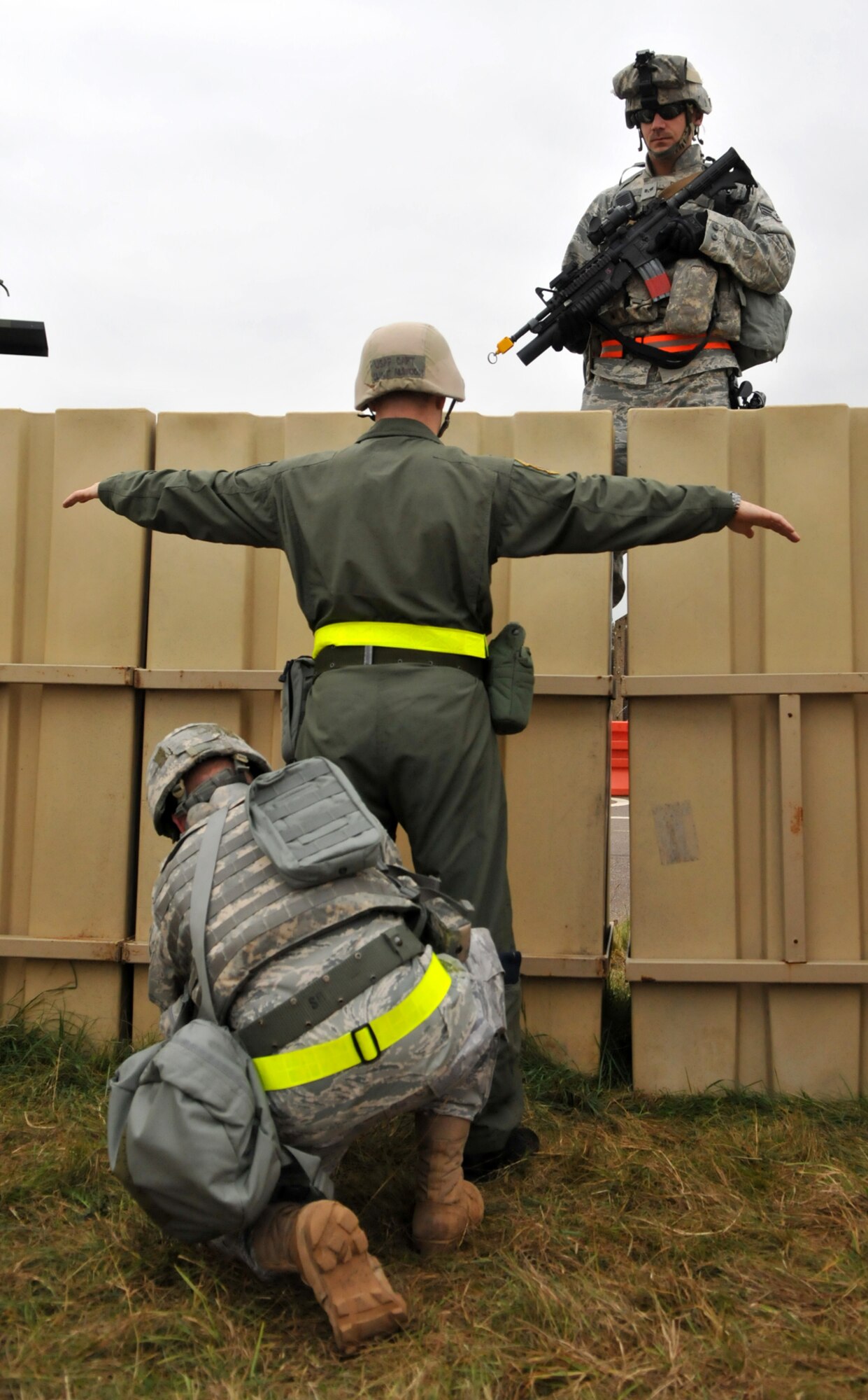 RAF MILDENHALL, England – While Senior Airman Patrick Dantzic provides overwatch, Senior Airman Johnny Keeton searches Capt. Clint Albaugh at an entry control point to “Base X,” a fictional airbase which serves as the simulated deployed location for the 100th Air Refueling Wing’s Operational Readiness Inspection.   The ECP is manned 24 hours a day by Airmen from the 100th Security Forces Squadron, who search vehicles and occupants before they’re allowed into the simulated airbase.  (U.S. Air Force photo/Staff Sgt. Austin M. May)