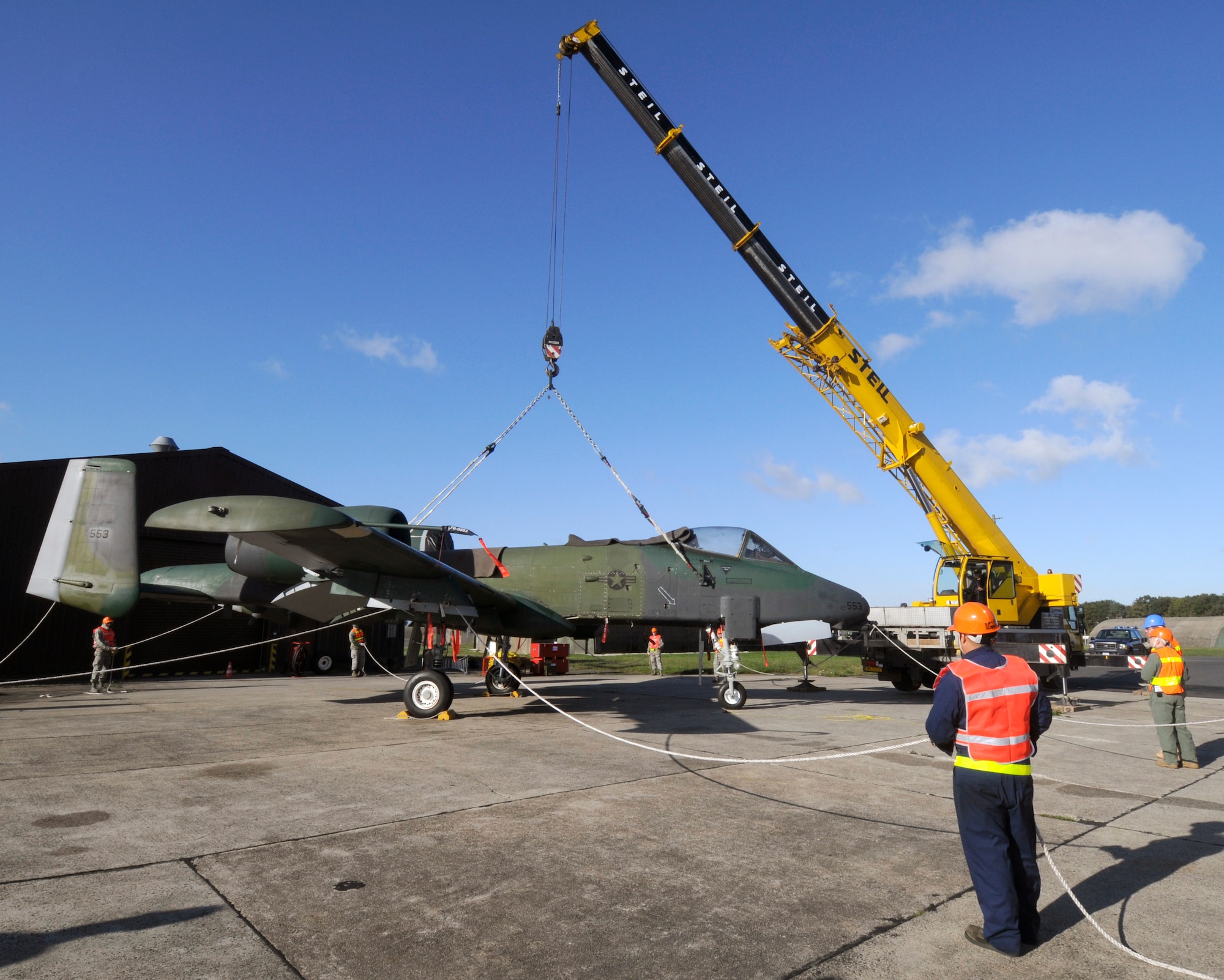 SPANGDAHLEM AIR BASE, Germany – Airmen stand ready to pull on guide lines attached to an A-10 Thunderbolt II to help maintain its position while it is being lifted by a crane here Oct. 14. The first Spangdahlem Crash-Damaged or Disabled Aircraft Recovery Course was hosted by the 52nd Equipment Maintenance Squadron and it qualifies crash-recovery Airmen to team-chief the process of lifting damaged aircraft for repairs and transportation. The training included Airmen from Spangdahlem, Lajes Field, Azores; Incirlik Air Base, Turkey; Ramstein Air Base, Germany; Royal Air Force Lakenheath, England; Chievres Garrison, Belgium; and Aviano Air Base, Italy. (U.S. Air Force photo/Senior Airman Benjamin Wilson)