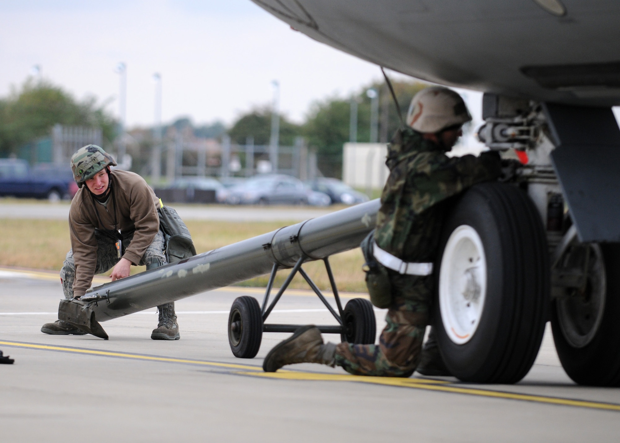 RAF MILDENHALL, England – Senior Airman Richardt Figueroa 100th Aircraft Maintenance Squadron crew chief, lines up a tow bar while Staff Sgt. Robert Seaburgh, connects it to the aircraft during a simulated fuel spill for the Operational Readiness Inspection Oct. 14. The ORI scenario tested the Airmen’s ability to effectively and safely react in an emergency situation. (U.S. Air Force photo/ Staff Sgt. Jerry Fleshman)