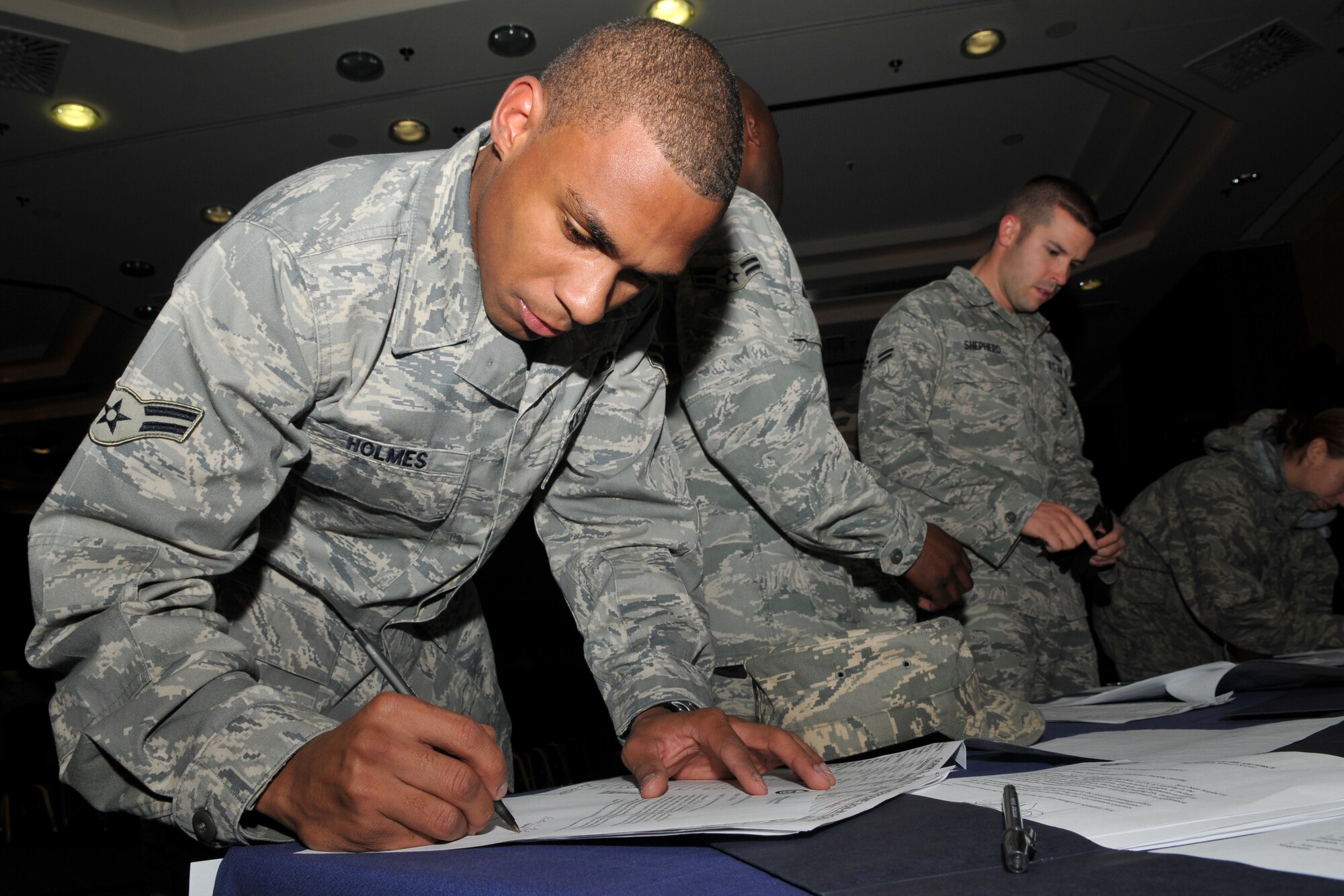 SPANGDAHLEM AIR BASE, Germany -- Airman 1st Class Antwaine Holmes, 52nd Logistics Readiness Squadron, signs in during a dorm resident all-call Oct. 13. Key topics discussed during the briefing were dorm improvements, the no-smoking policy, base dorm council, and dorm or bay chief program. (U.S. Air Force photo/Airman 1st Class Nick Wilson)