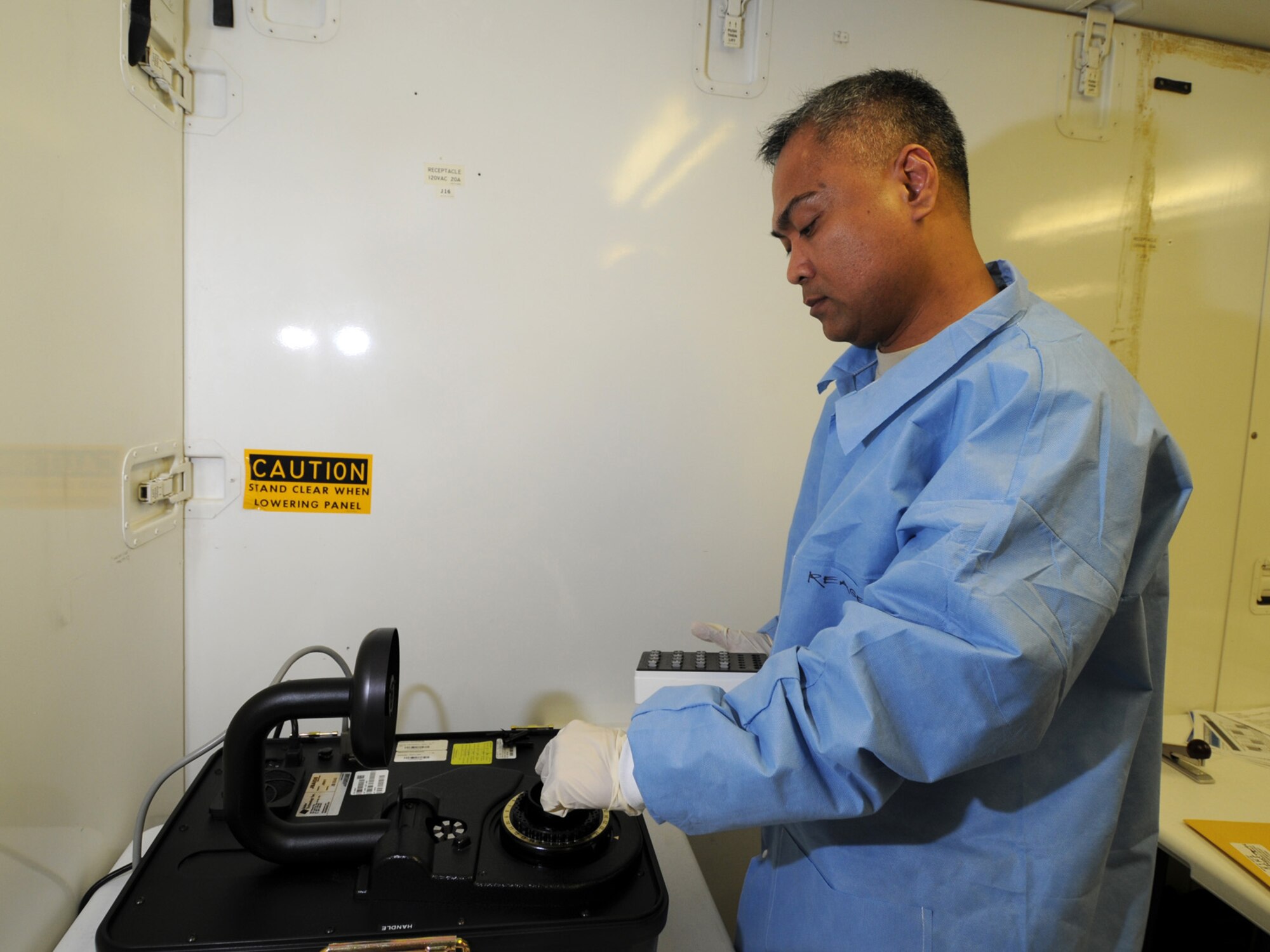 U.S. Air Force Maj. Lorenzo Gabiola, 379th Expeditionary Medical Group biological augmentation team chief, analyzes a sample, Oct. 13, 2009, using the base's new Joint Biological Agent Identification and Diagnostic System, which amplifies ribonucleic acid for H1N1 detection. Members of the 379 EMDG BAT team are the first Air Force personnel certified in detecting H1N1 using this technology. Major Gabiola is deployed from Tinker Air Force Base, Okla. in support of operations Iraqi Freedom and Enduring Freedom. (U.S. Air Force Photo/Tech Sgt. Jason W. Edwards)