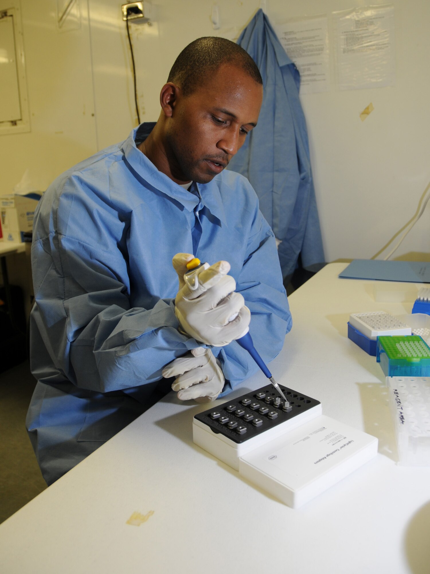 U.S. Air Force Tech. Sgt. Vernon Smith, 379th Expeditionary Medical Group biological augmentation team NCOIC, adds an extracted sample and reagents to glass capillaries, Oct. 13, 2009, for use in the Joint Biological Agent Identification and Diagnostic System. Members of the 379 EMDG BAT team are the first Air Force personnel certified in detecting H1N1 using JBAIDS technology. Sergeant Smith is deployed from Tinker Air Force Base, Okla. in support of operations Iraqi Freedom and Enduring Freedom. (U.S. Air Force Photo/Tech Sgt. Jason W. Edwards)