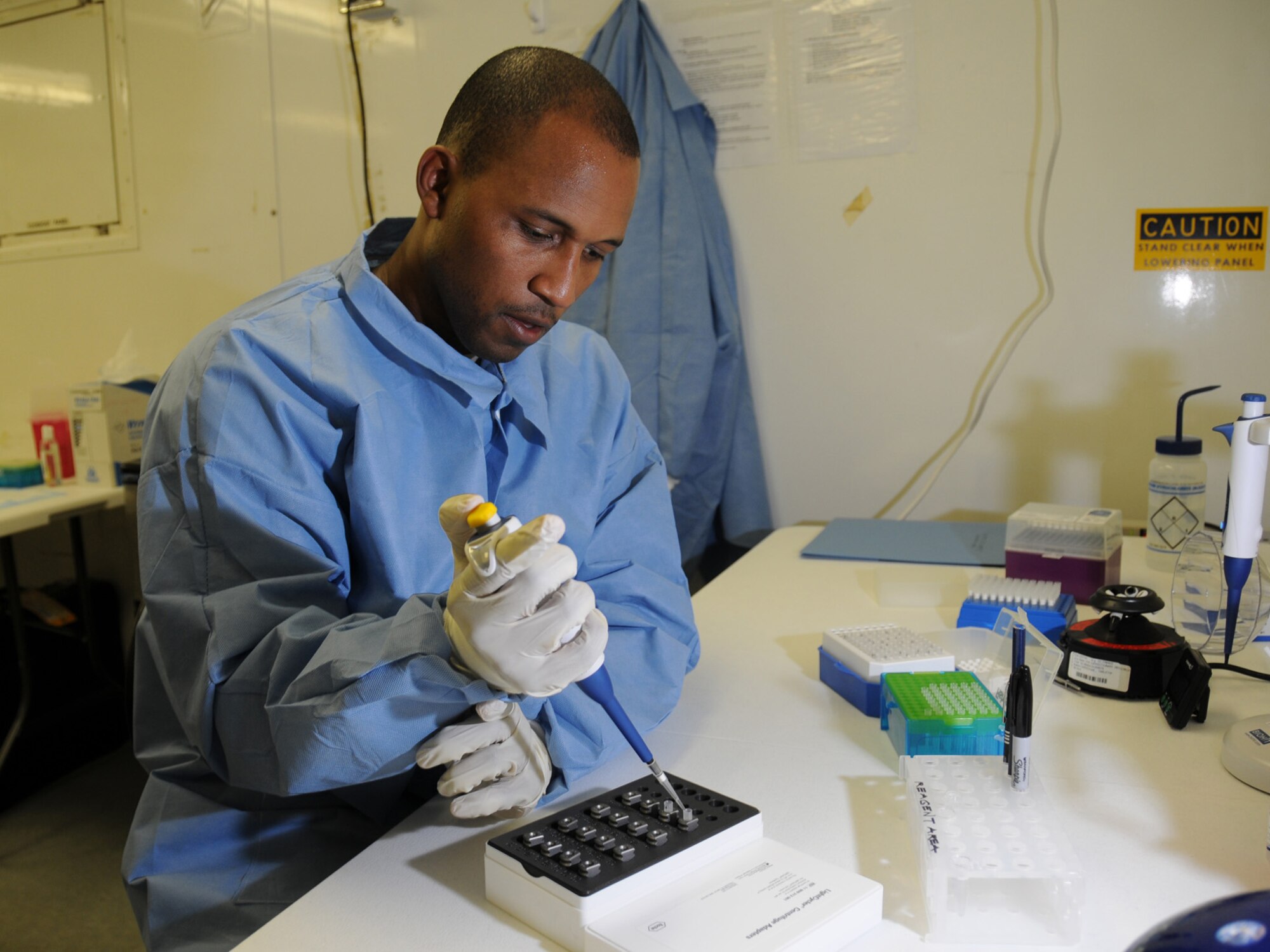 U.S. Air Force Tech. Sgt. Vernon Smith, 379th Expeditionary Medical Group biological augmentation team NCOIC, adds an extracted sample and reagents to glass capillaries, Oct. 13, 2009, for use in the Joint Biological Agent Identification and Diagnostic System. Members of the 379 EMDG BAT team are the first Air Force personnel certified in detecting H1N1 using JBAIDS technology. Sergeant Smith is deployed from Tinker Air Force Base, Okla. in support of operations Iraqi Freedom and Enduring Freedom. (U.S. Air Force Photo/Tech Sgt. Jason W. Edwards)