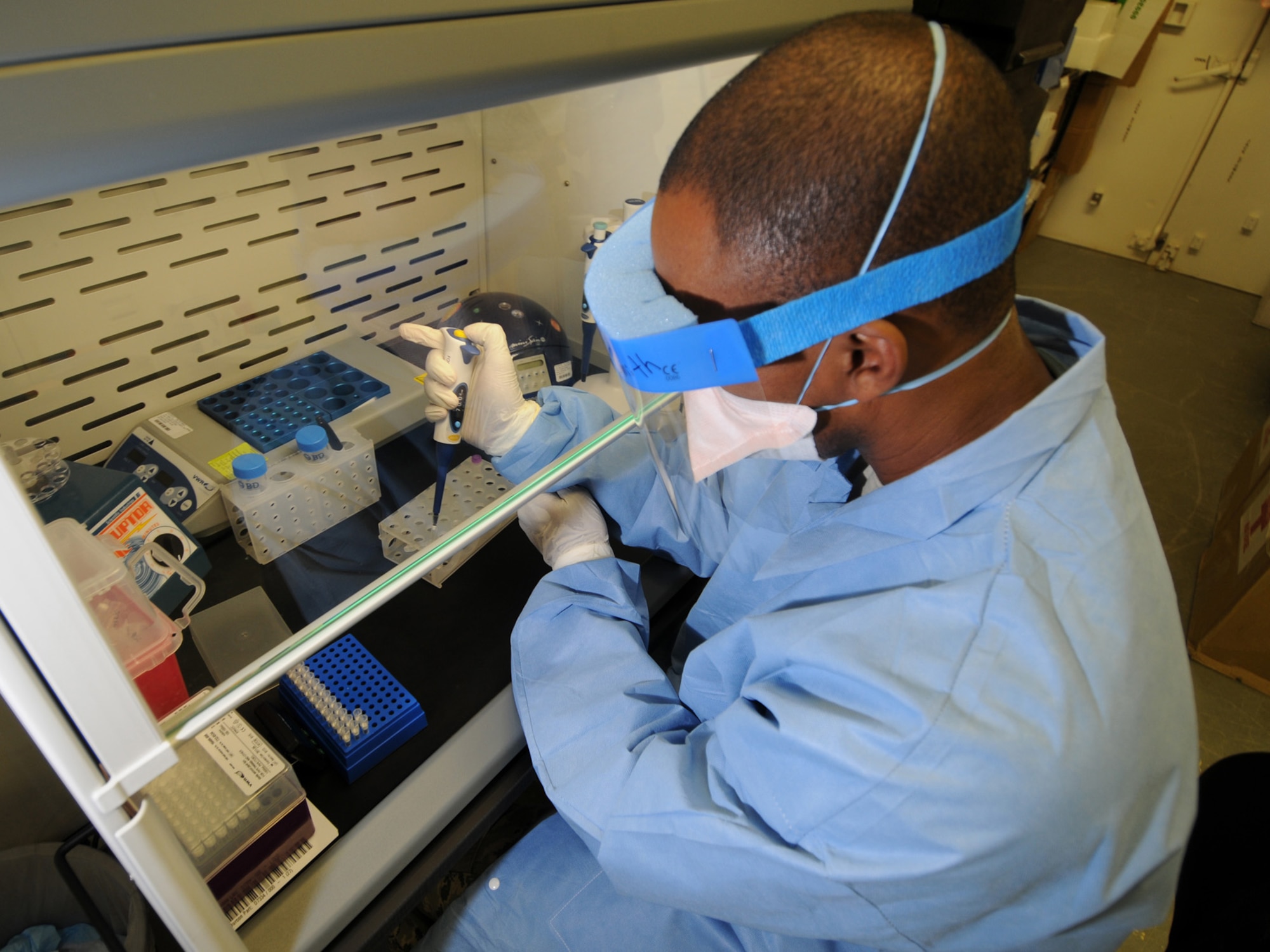 U.S. Air Force Tech. Sgt. Vernon Smith, 379th Expeditionary Medical Group biological augmentation team NCOIC, extracts ribonucleic acid from a nasopharyngeal swab sample for H1N1 screening, Oct. 13, 2009, using the Joint Biological Agent Identification and Diagnostic System. Members of the 379 EMDG BAT team are the first Air Force personnel certified in detecting H1N1 using JBAIDS technology. Sergeant Smith is deployed from Tinker Air Force Base, Okla. in support of operations Iraqi Freedom and Enduring Freedom. (U.S. Air Force Photo/Tech Sgt. Jason W. Edwards)