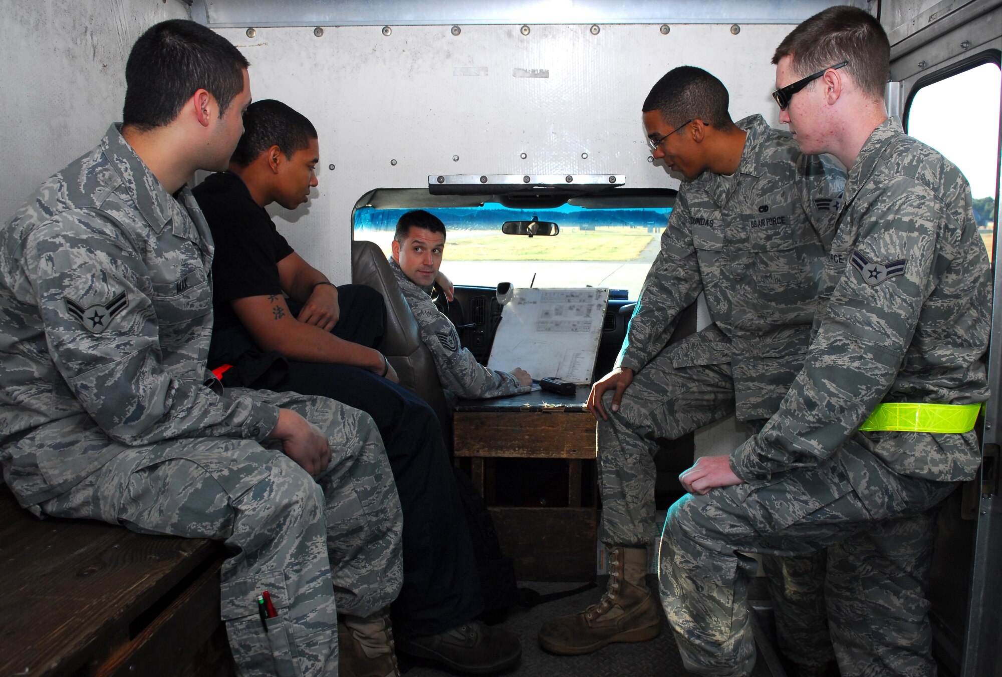 MISAWA AIR BASE, Japan -- Tech. Sgt. Douglas Frank, 14th Aircraft Maintenance Unit airframe power plant general expeditor, leans over the clip board and explains to the crew chiefs on the truck what maintenance will be required of them Oct. 14 on the 14th AMU’s ramp. Crew chiefs are responsible for inspections, servicing and general maintenance of the F-16 Fighting Falcon. (U.S. Air Force photo/Staff Sgt. Phillip Butterfield)