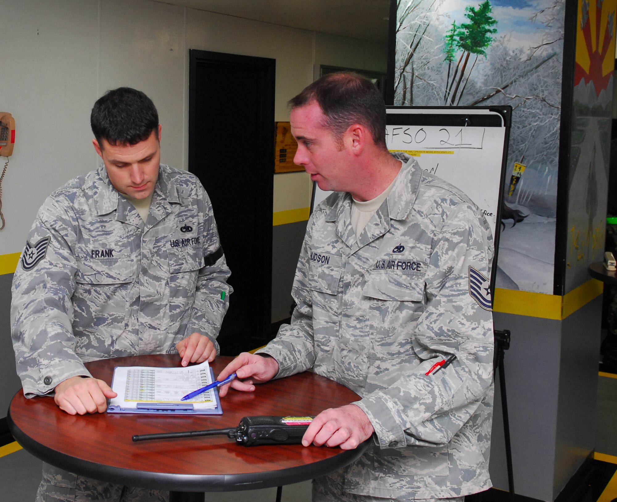 MISAWA AIR BASE, Japan -- Tech. Sgt. Douglas Frank, 14th Aircraft Maintenance Unit airframe power plant general expeditor, receives a turn over from Tech. Sgt. Christopher Hudson, 14th AMU flightline expeditor, on what tasks have been accomplished Oct. 10 on the 14th Amu's flightline . Maintenance turn overs are important for ensuring all flightline activities are accounted for and nothing gets overlooked. (U.S. Air Force photo/Staff Sgt. Phillip Butterfield)