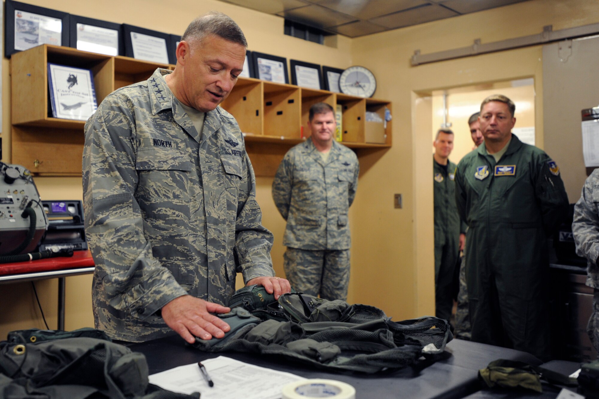 Pacific Air Forces Commander Gen. Gary North examines a flight vest in the 36th Fighter Squadron building after arriving at Osan Air Base Republic of Korea Oct. 7.  During their visit Gen. North and his wife Shelley visited with Airmen and their families to discuss the way ahead for Team Osan.  (U.S. Air Force photo/ Senior Airman Stephenie Wade)
