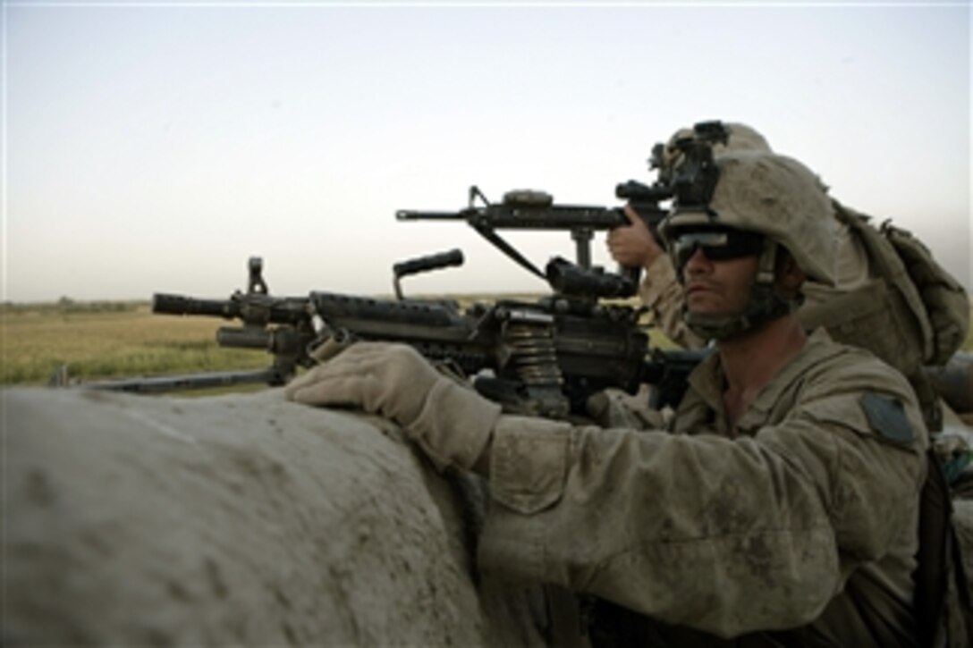U.S. Marines with 2nd Battalion, 8th Marine Regiment observe the movement of enemy forces during an attack at Patrol Base Bracha in the Garmsir district of Helmand province, Afghanistan, on Oct. 9, 2009.  The Marines are deployed with Regimental Combat Team 3, whose mission is to conduct counterinsurgency operations in partnership with Afghan security forces in southern Afghanistan.  