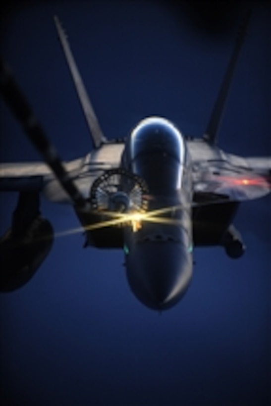 A U.S. Navy F/A-18 Hornet aircraft receives fuel from a U.S. Air Force 908th Expeditionary Air Refueling Squadron KC-10A Extender aircraft over Afghanistan on Oct. 5, 2009.  