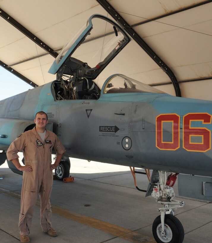 Air Force Capt. Ryan Corrigan, an exchange pilot, stands next to an F-5N Tiger II of Marine Fighter Training Squadron 401 on the flight line at the Marine Corps Air Station in Yuma, Ariz., Oct. 15, 2009. The two-year program is highly competitive among Air Force pilots and affords them the opportunity to train in the various types of air-to-ground operations Marine pilots fly.