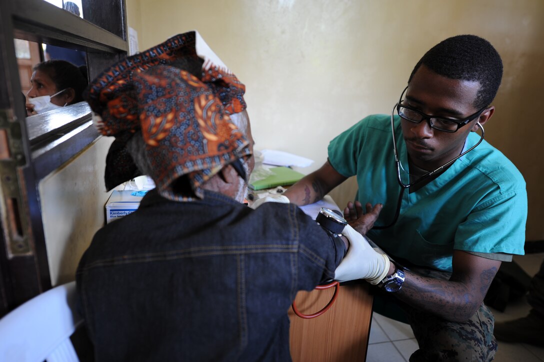 Seaman Ronald Shaw, 20, from Houston, takes the blood pressure of an East Timorese woman at a clinic here Oct. 15. Shaw, a hospital corpsman, and other medical personnel with the 11th Marine Expeditionary Unit are in Timor Leste providing medical and dental services as part of an exercise with the military there.