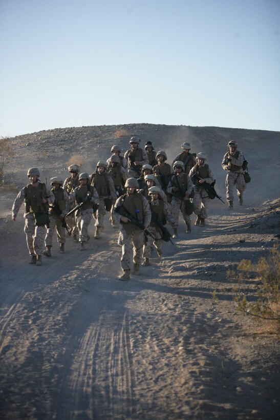 Marines with the Combat Center’s Consolidated Material Support Center march down a hill during an eight-mile training hike Oct. 16, aboard the Combat Center. CMSC completed the hike in preparation for their participation in an upcoming Darkside Derby.