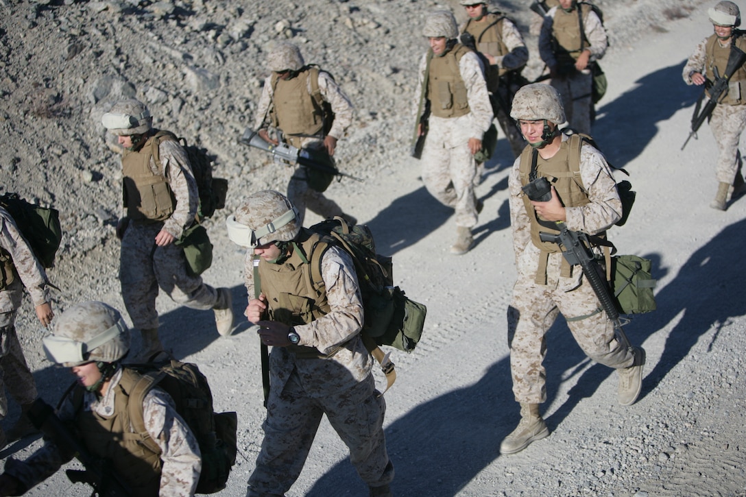 Marines with the Combat Center’s Consolidated Material Support Center march forward after completing half of their 8-mile training hike Oct. 16, aboard the Combat Center. CMSC completes hikes such as this in preparation for the Darkside Derby in December.