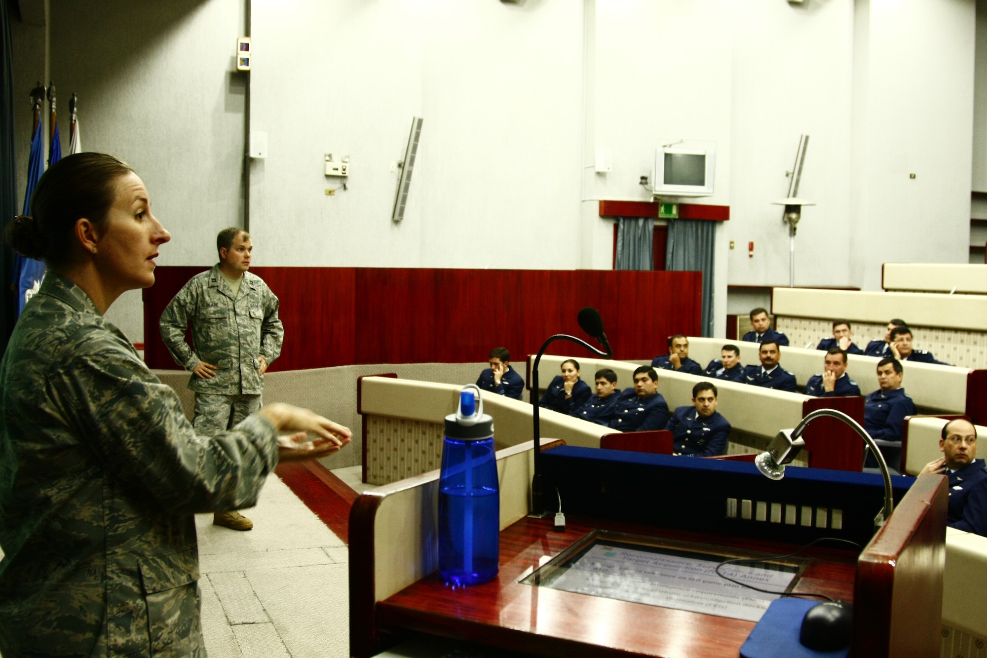 SANTIAGO, Chile -- Maj. Jana Nyerges and Capt. Rick Glade, Air Operations Center experts with Twelfth Air Force (Air Forces Southern), brief students at the Chilean Air War College during a Cooperation Team-One exchange in Santiago, Chile.  The team was in Chile to exchange ideas and best practices with members of the Chilean Air Force prior to participating in Excercise SALITRE later this month. (U.S. Air Force photo by Capt. Nathan Broshear)