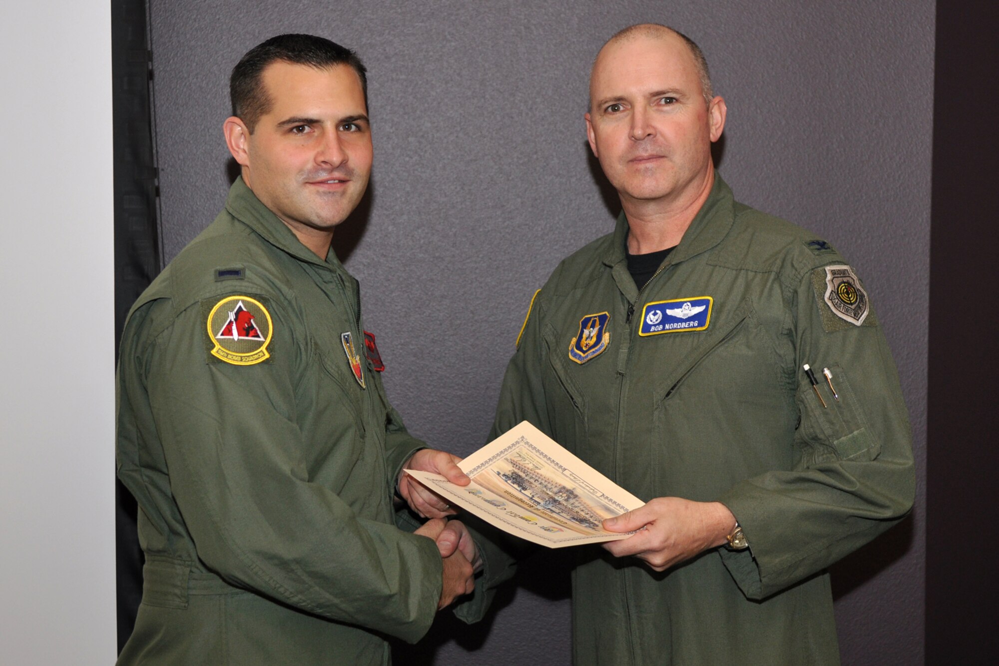 Colonel Robert Nordberg, 917th Operations Group, commander, presents a certificate of recognition to 1st Lt. Ryan D. Ruediger, during graduation ceremonies for FTU Class 09-02 at Barksdale Air Force Base, La., October 16, 2009. Lieutenant Ruediger was the Distinguished Graduate for the B-52 Electronic Warfare Officer Initial Qualification Course. The entire course lasted 32 weeks and 4 days. (U.S. Air Force photo/Tech. Sgt. Jeff Walston)