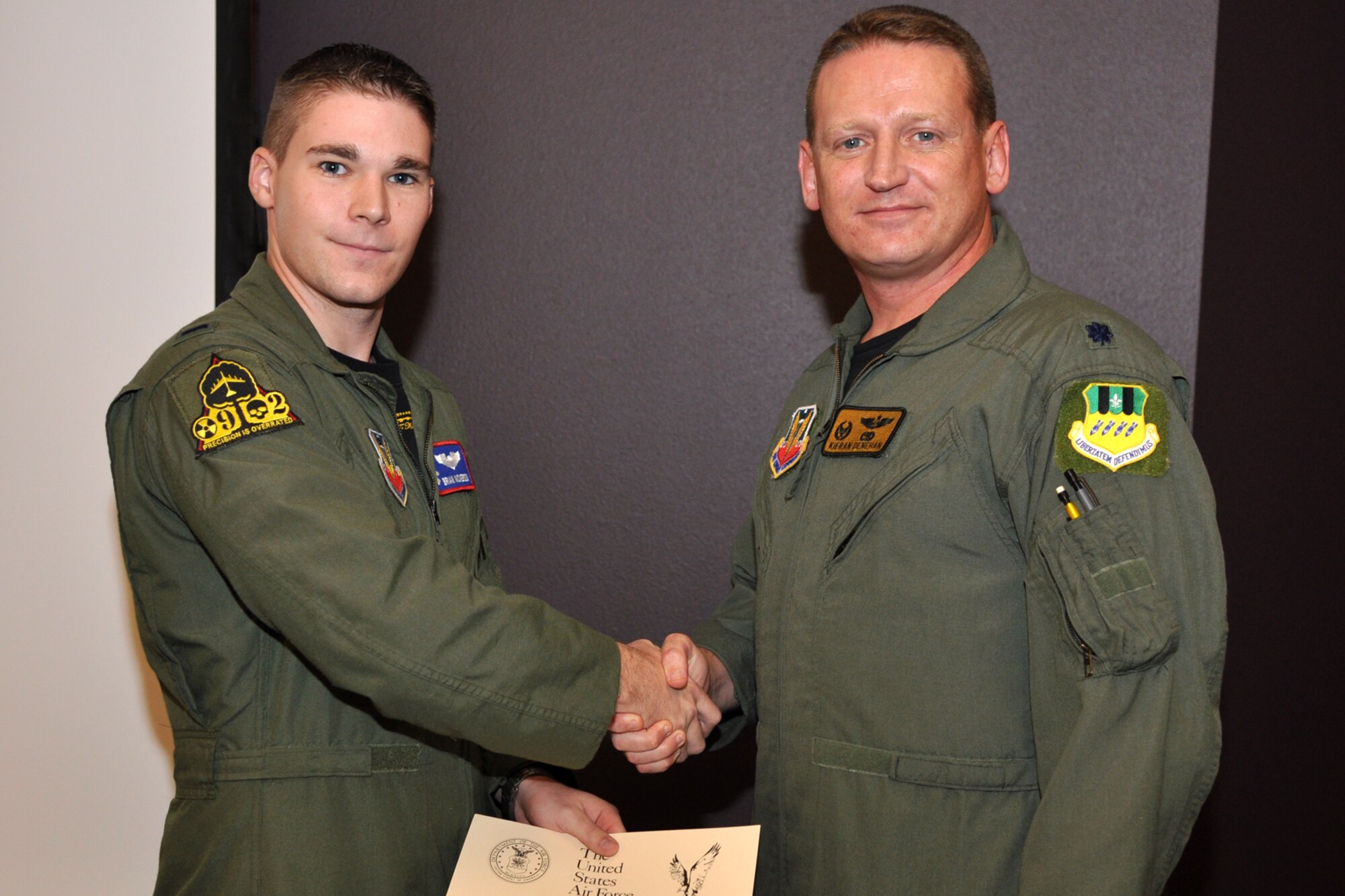 Lt. Col. Kieran Denehan, 11th Bomb Squadron, commander, presents a certificate of graduation to 1st Lt. Brian C. Nickerson, during graduation ceremonies for FTU Class 09-02 at Barksdale Air Force Base, La., October 16, 2009. Lieutenant Nickerson graduated from the B-52 Pilot Initial Qualification Course.  The entire course lasted 32 weeks and 4 days. (U.S. Air Force photo/Tech. Sgt. Jeff Walston)
