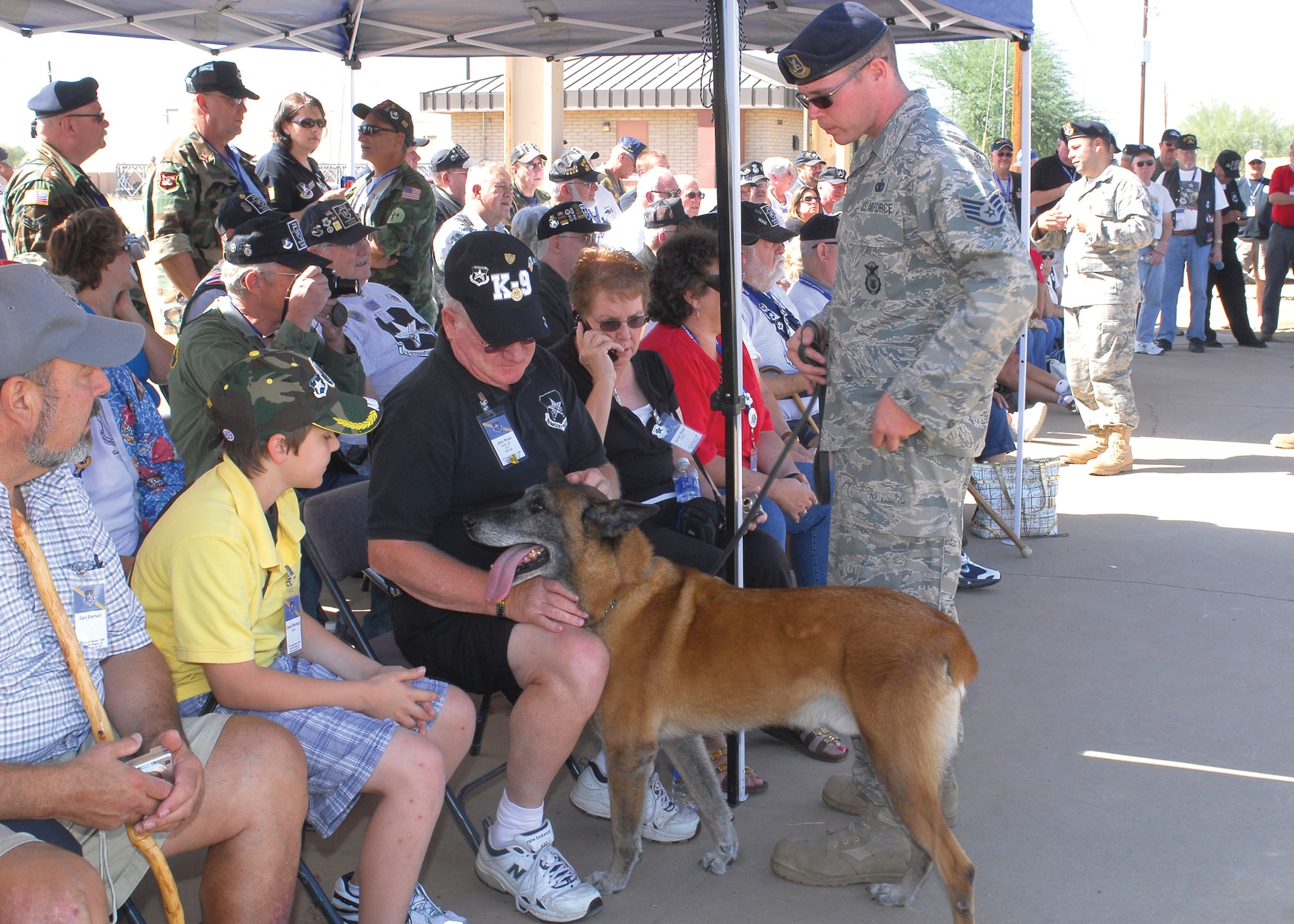 Jampy, a military working dog, greets Mr. John Risse, a former Staff Sgt. assigned to the 633rd Security Police Squadron at Pleiku Air Base, Vietnam, at the kennels during the VSPA (Vietnam Security Police Association) 15th annual reunion tour with the 56th Security Forces Squadron, Oct. 9. (U.S. Air Force photo by Senior Airman Tracie Forte)