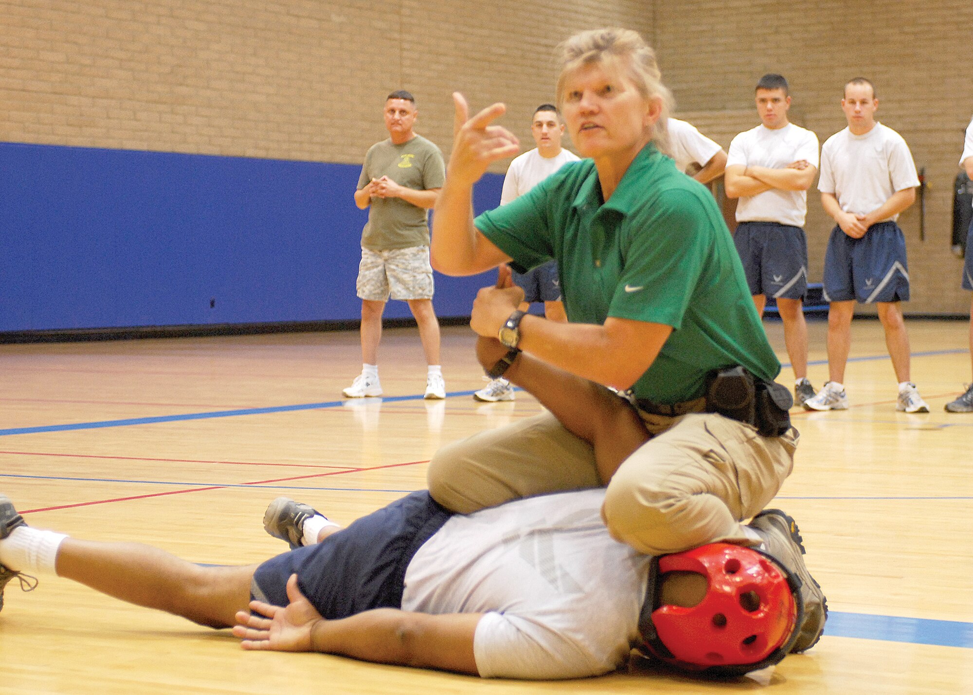 Ms. Susan Baldwin demonstrates self-defense tactics taught during SPEAR (Spontaneous Protective Enabling Accelerated Response) training to members of the VSPA (Vietnam Security Police Association) at the Fitness Center during their 15th annual reunion and tour with the 56th Security Forces Squadron, Oct. 9. (U.S. Air Force photo by Senior Airman Tracie Forte)