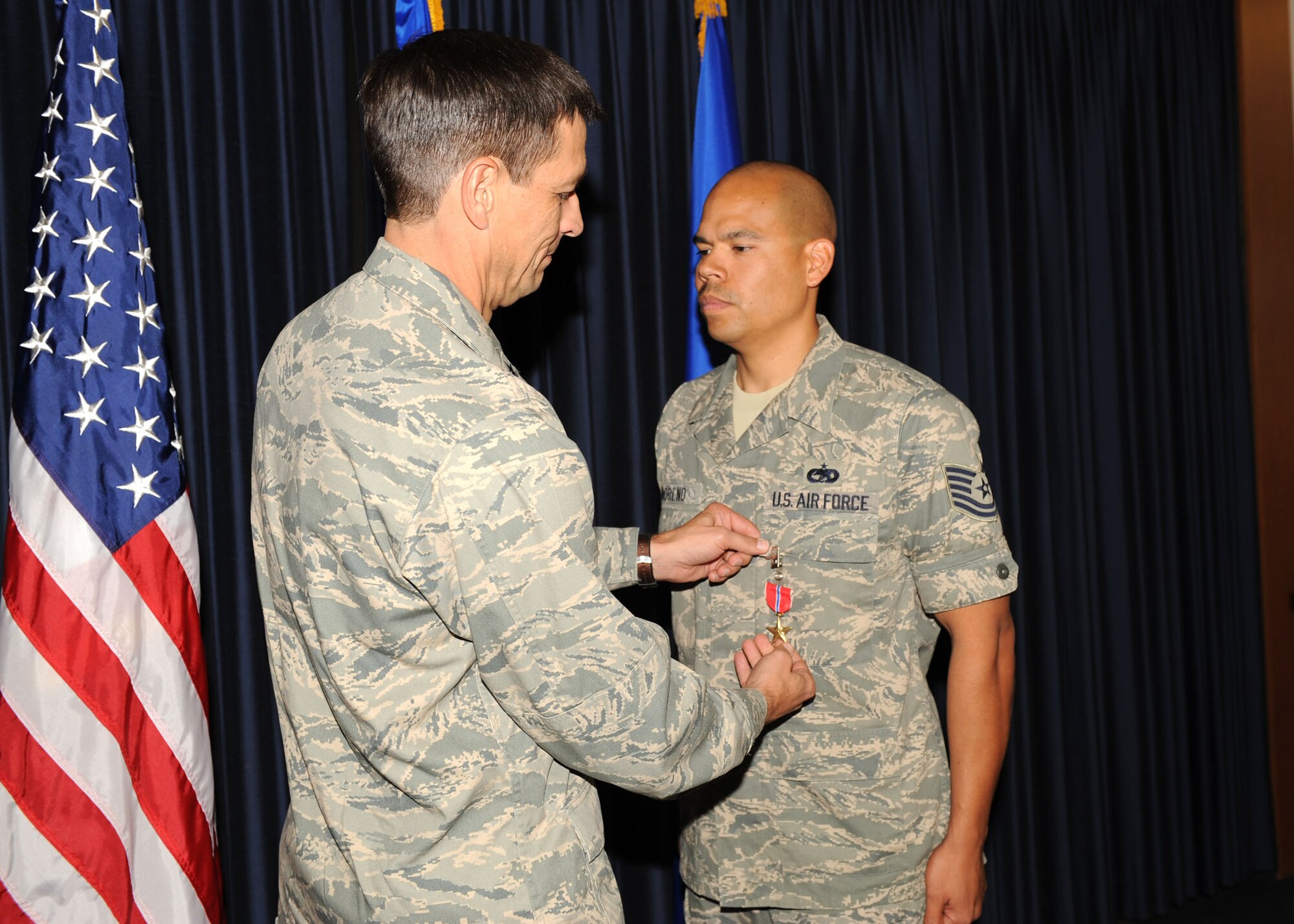 Brig. Gen. Paul Johnson, 355th Fighter Wing commander, presents Tech. Sgt. Rudy Moreno, 35th Fighter Wing, with the U.S. Army Bronze Star medal for outstanding work while deployed to Camp Arifjan, Kuwait, Iraq, here Oct 16. Sergeant Moreno received this award the leadership he displayed during convoys throughout Iraq. (U.S. Air Force photo/Airman 1st Class Brittany Dowdle) 