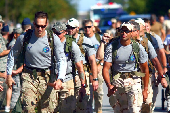 HURLBURT FIELD, Fla. -- Twelve special tactics Airmen enter the base as they conclude an 824-mile memorial ruck sack march at Hurlburt Field Oct. 16, 2009. The men marched from San Antonio to Hurlburt Field to honor Staff Sgt. Timothy Davis, a combat controller assigned to the 23rd Special Tactics Squadron when he was killed in action Feb. 20, 2009, and 12 other fallen special tactics members. (U.S. Air Force photo by Drew Buchanan) 
