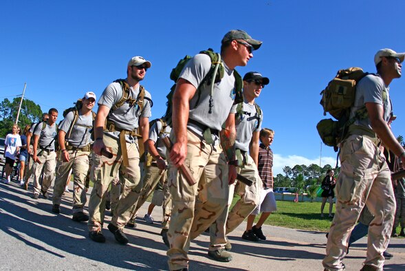 HURLBURT FIELD, Fla. -- Twelve special tactics Airmen enter the base as they conclude an 824-mile memorial ruck sack march at Hurlburt Field Oct. 16, 2009. The men marched from San Antonio to Hurlburt Field to honor Staff Sgt. Timothy Davis, a combat controller assigned to the 23rd Special Tactics Squadron when he was killed in action Feb. 20, 2009, and 12 other fallen special tactics members. (U.S. Air Force photo by Drew Buchanan) 
