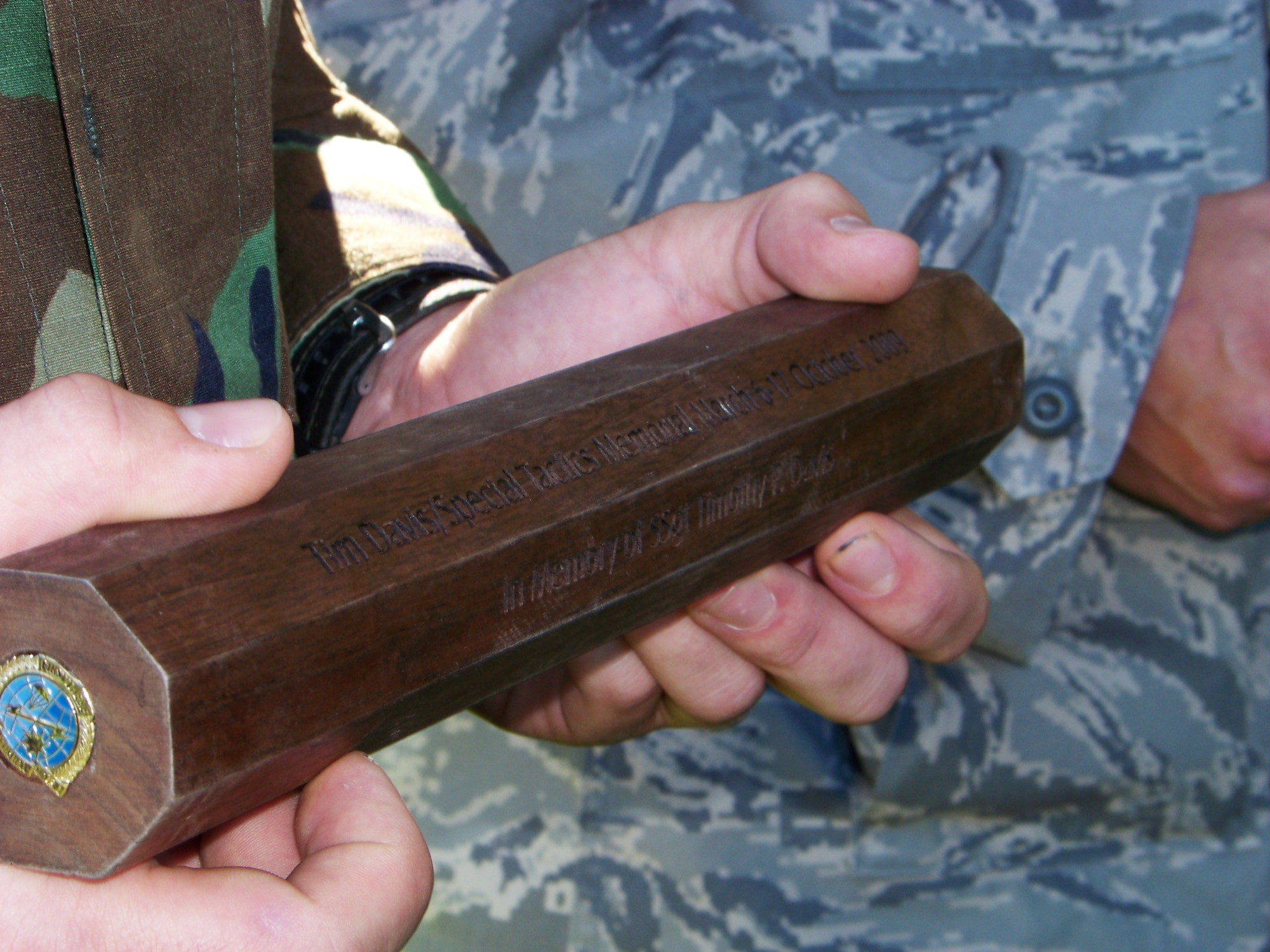 HURLBURT FIELD, Fla. -- A baton engraved with the name of Staff Sgt. Timothy Davis was presented to the Special Tactics Training Squadron commander during a ceremony here Oct. 16, 2009. Sergeant Davis, a fallen combat controller who was assigned to the 23rd Special Tactics Squadron, and 12 other special operations forces members were honored in an 824-mile rucksack march from San Antonio to Hurlburt Field where the baton will be permanently displayed. (U.S. Air Force photo by Staff Sgt. Mareshah Haynes)