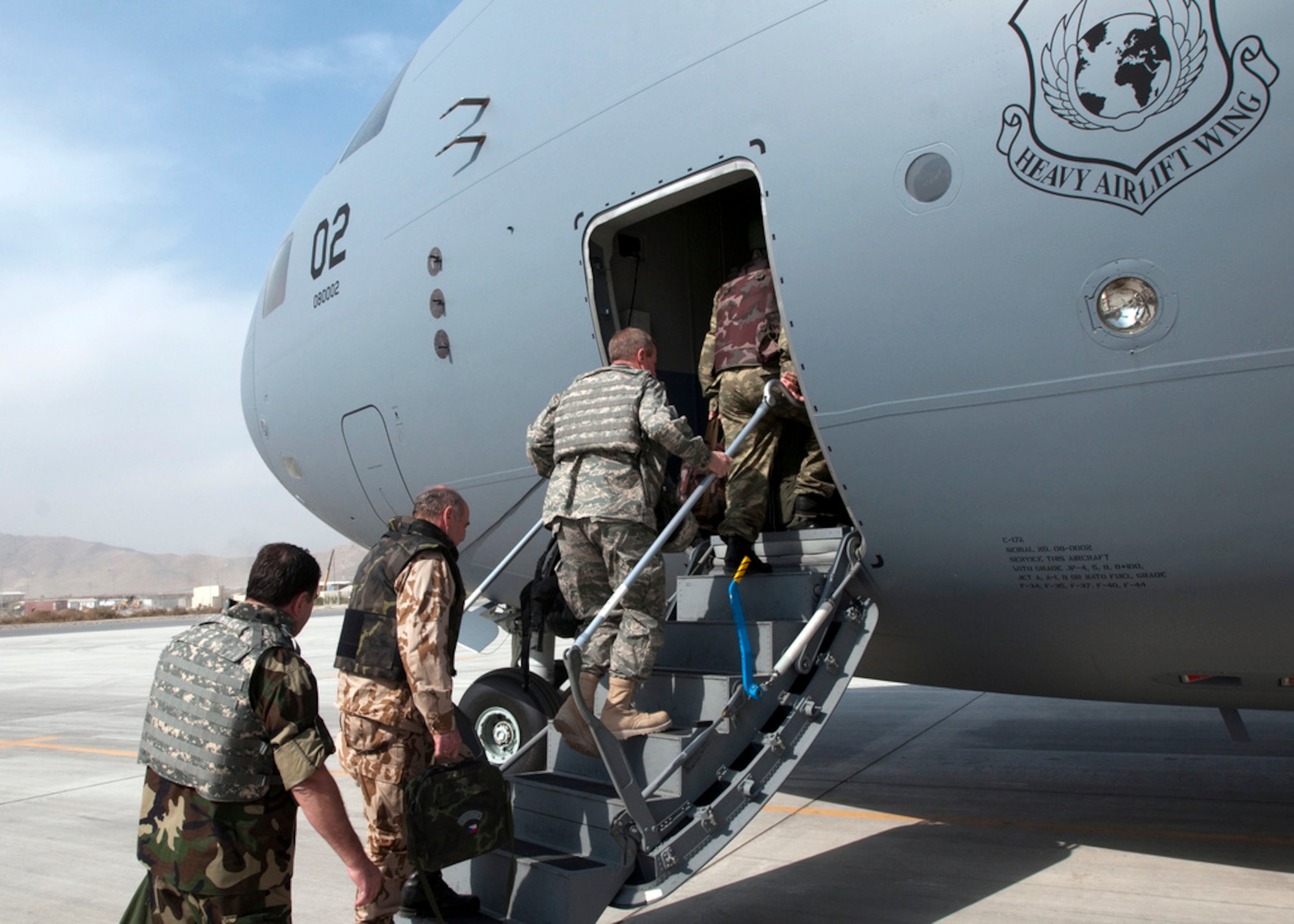 Members of the NATO International Military Committee board a C-17 Globemaster III from the multinational Heavy Airlift Wing at Papa Air Base, Hungary. The newly formed HAW, flew one of its three C-17 Globemaster IIIs into Kabul, Afghanistan, with military representatives from all 28 NATO member states as well as those from the 14 non-NATO nations who also contribute forces to ISAF. The consortium includes NATO member nations Bulgaria, Estonia, Hungary, Lithuania, the Netherlands, Norway, Poland, Romania, Slovenia and the U.S., as well as Partnership for Peace nations Finland and Sweden. (U.S. Air Force photo/Navy Petty Officer 1st Class Ryan Tab)