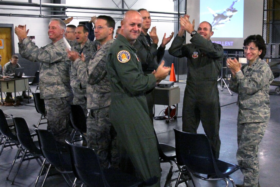 Maj. Gen. Maria Falca-Dodson, right, Commander, New Jersey Air National Guard, leads members of the 177th Fighter Wing leadership in applauding the Airmen of the 177th Fighter Wing for receiving an "Excellent" rating for the Operational Readiness Inspection.  On Oct. 8, the Air Combat Command Inspector General briefed the Airmen of the 177th Fighter Wing and  leadership of the New Jersey Air National Guard on the results of the Wing's Operational Readiness Inspection, which was held Oct. 3-5, 2009. (U.S. Air Force photo/Tech. Sgt. Mark Olsen)