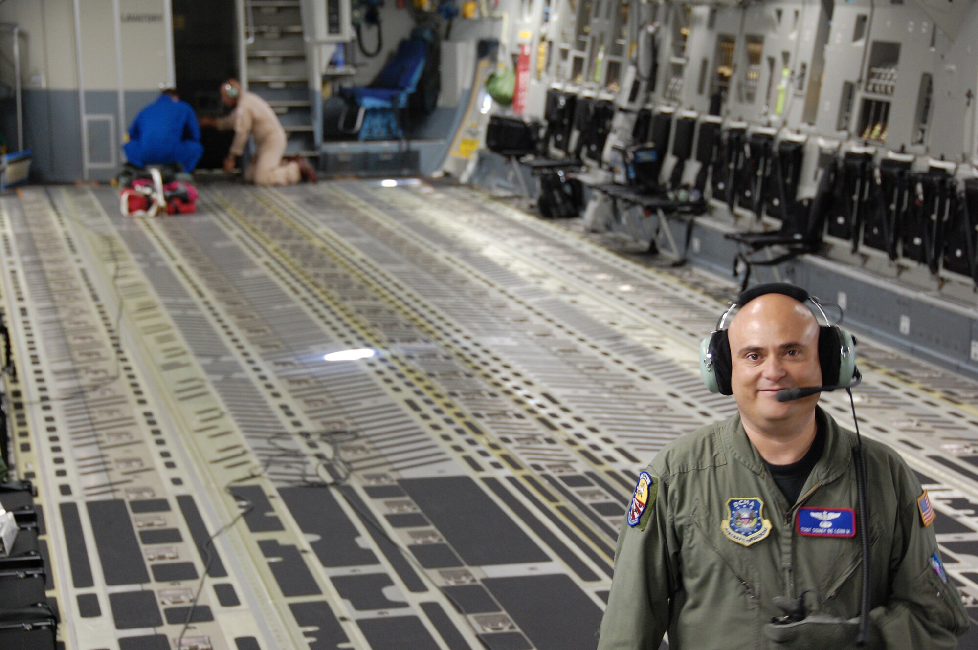 Tech. Sgt. Sidney De Leon works with a Boeing loadmaster and engineer in checking a C-17 Globemaster III for cabin pressurization leaks Oct. 15, 2009, at Long Beach, Calif. Sergeant De Leon is a Defense Contract Management Agency C-17 acceptance crew member. (U.S. Air Force photo/Col. Michael Coolidge) 