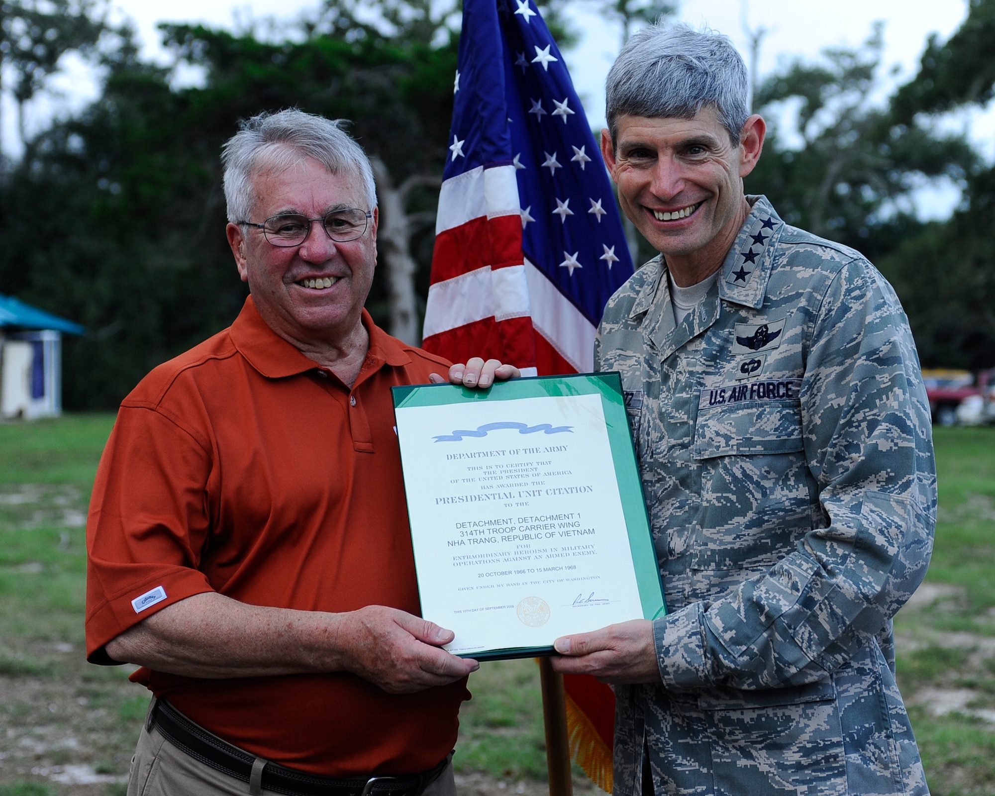 Air Force Chief of Staff Gen. Norton Schwartz, right, presents retired Col. Douglas Forsythe, with the Presidential Unit Citation for Det. 1. 314th Troop Carrier Wing at the Stray Goose International Air Commando reunion at the Soundside on Hurlburt Field, Oct. 9, 2009. (U. S. Air Force photo by Senior Airman Julianne M. Showalter/Released)