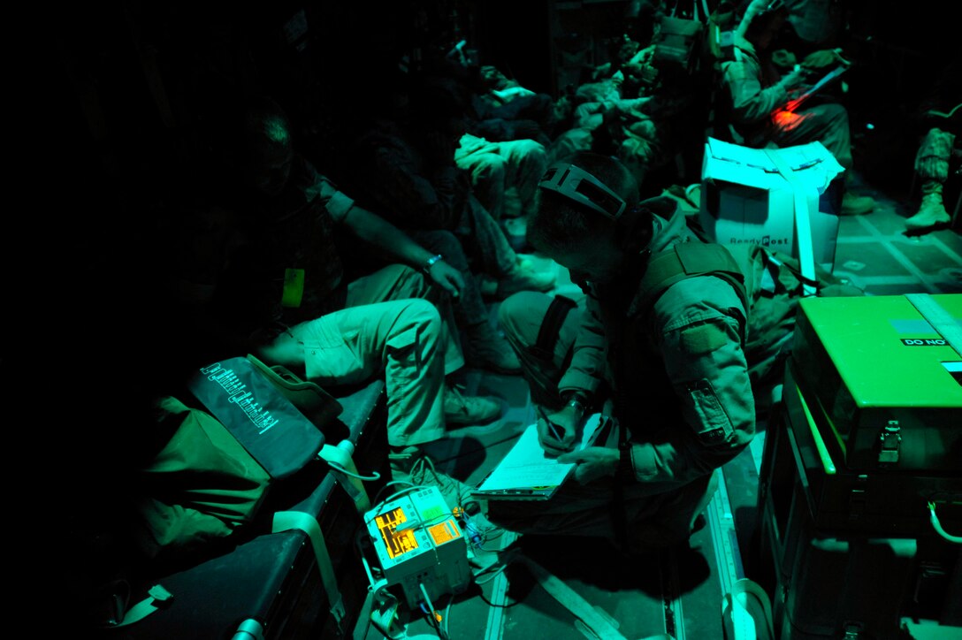 Master Sgt. Timothy Starkey works aboard an HC-130 Hercules during a mission Oct. 6, 2009. Sergeant Starkey is a medical technician assigned to the 451st Aeromedical Squadron at Kandahar Airfield, Afghanistan. (U.S. Air Force photo/Staff Sgt. Angelita Lawrence)