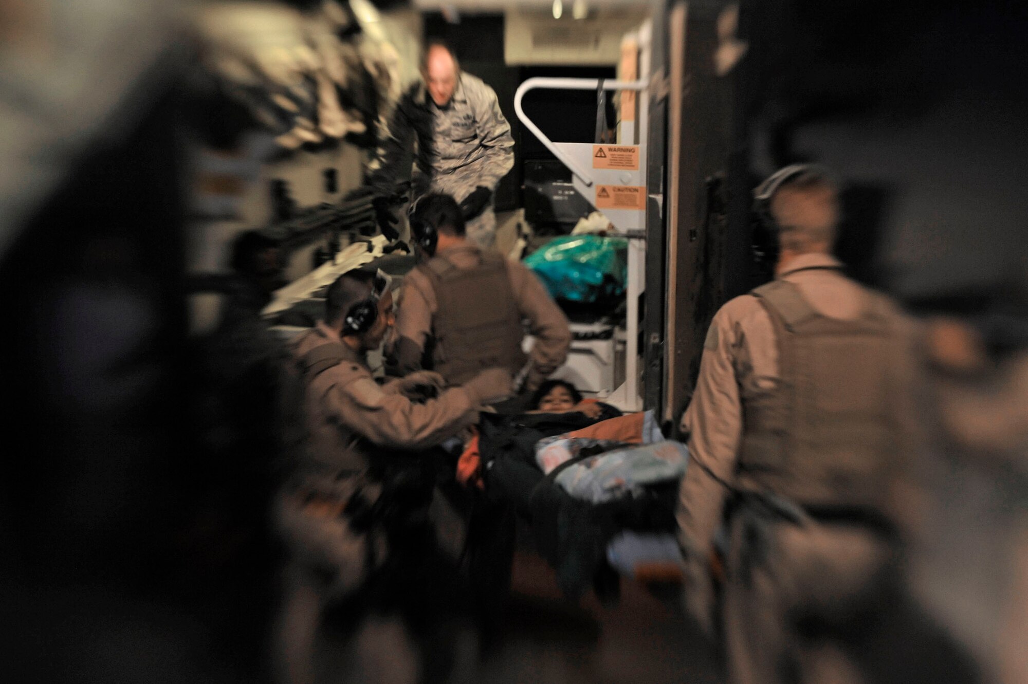 Airmen transport an Afghan patient to a higher level of care at Camp Bastion Oct. 6, 2009. The U.S. Air Force provides care to patients from the U.S., coalition partners and locals on a daily basis. These Airmen are assigned to the 451st Aeromedical Squadron at Kandahar Airfield, Afghanistan.  (U.S. Air Force photo/Staff Sgt. Angelita Lawrence) 