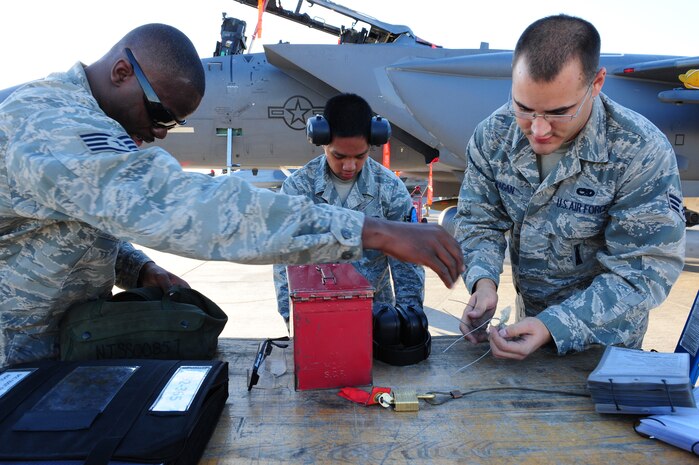NELLIS AIR FORCE BASE, Nev. --  Staff Sgt. Jonathan Agbeyegbe, Airman 1st Class Matthew Cruz and Senior Airman Alexander Pagan, load crew members from the 757th Aircraft Maintenance Squadron, distribute tools during the Weapons Load Crew Competition on the Nellis flight line, Oct. 9.  The quarterly weapons load crew competition tests the skills of airman on six different teams. The Airmen are judged on speed, accuracy and safety.
(U.S. Air Force Photo / Staff Sgt William P. Coleman)