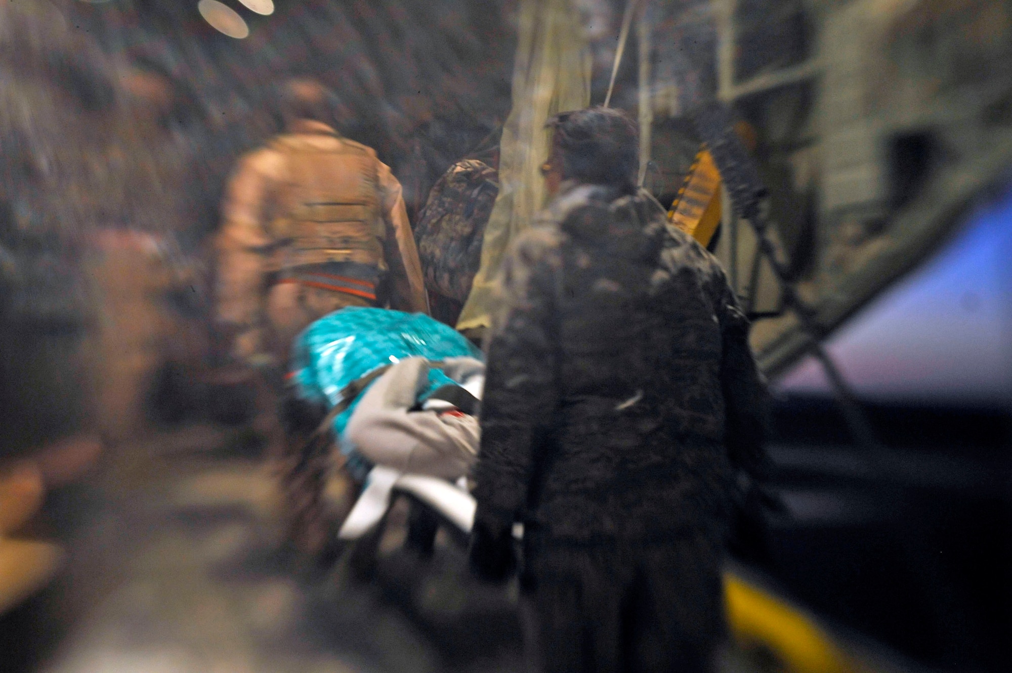 Airmen transport an Afghan patient into an HC-130 Hercules at Camp Bastion, Afghanistan Oct. 6, 2009. These Airmen are assigned to the 451st Aeromedical Squadron at Kandahar Airfield, Afghanistan. (U.S. Air Force photo/Staff Sgt. Angelita Lawrence)