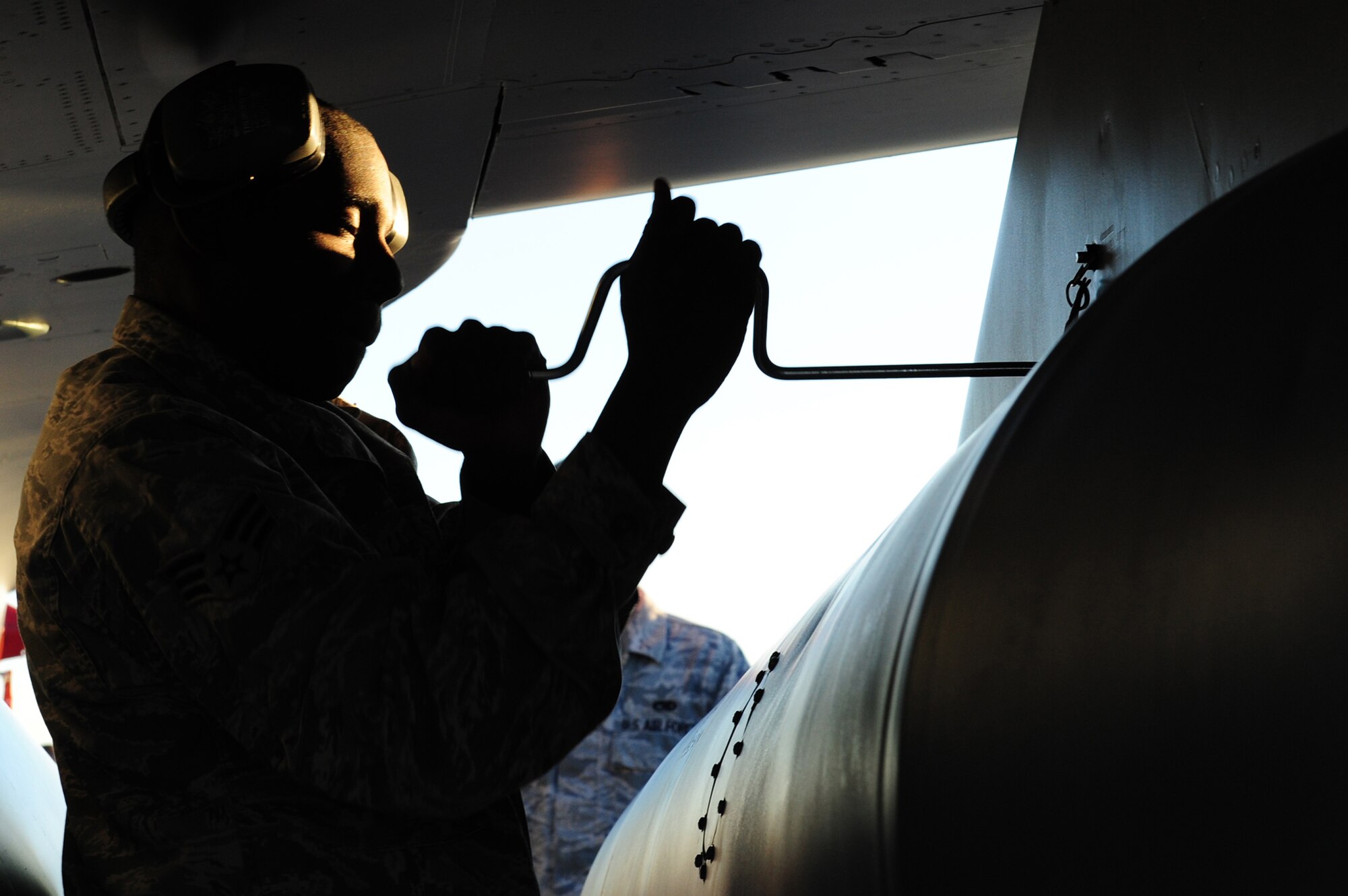 NELLIS AIR FORCE BASE, Nev.-- Senior Airman JaVaughn Harris, 16th Weapons Squadron load crew member, tightens a bomb on an F-16 Fighting Falcon during the Weapons Load Crew Competition on the Nellis  flight line, Oct. 9. The quarterly weapons load crew competition tests the skills of Airmen on six different teams. The Airmen are judged on speed, accuracy and safety.
(U.S. Air Force Photo / Staff Sgt. William P.Coleman)