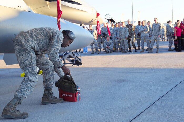 NELLIS AIR FORCE BASE, Nev.-- Senior Airman JaVaughn Harris, 16th Weapons Squadron load crew member, rushes to his tool bag during the Weapons Load Crew Competition on the Nellis  flight line, Oct. 9. The quarterly weapons load crew competition tests the skills of Airmen on six different teams. The Airmen are judged on speed, accuracy and safety.
(U.S. Air Force Photo / Staff Sgt. William P. Coleman)
