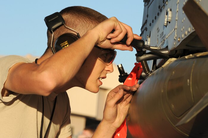 NELLIS AIR FORCE BASE, Nev.-- Airman 1st Class Matthew Quick from the 57th Aircraft Maintenance Squadron secures a bomb to an A-10 Thunderbolt II during the Weapons Load Crew Competition on the Nellis flight line, Oct. 9, 2009. The bi-monthly weapons load crew competition tests the skills of Airmen on six different teams. The Airmen are judged on speed, accuracy and safety.
(U.S. Air Force Photo / Airman 1st Class Jamie Nicley)
