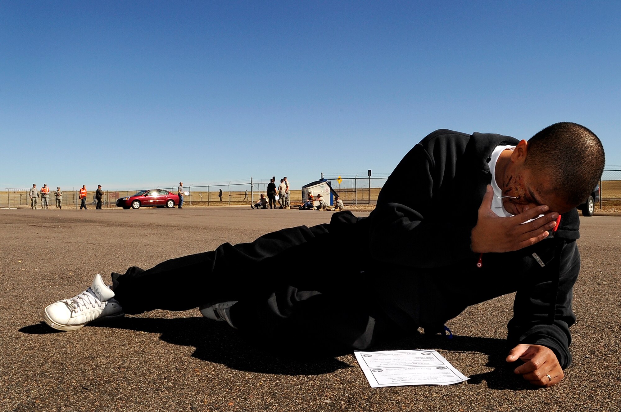 Buckley Air Force Base, Colo. -- Airman 1st Class Bryan Waller, 460th Force Support Squadron, acts as a victim with a head injury during an exercise, Oct. 16, 2009, Buckley Air Force Base, Colo. (U.S. Air Force photo by Staff Sgt Steve Czyz)