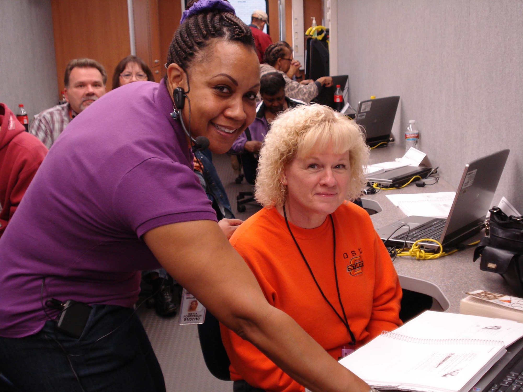Inetta Robertson, an Inventory Management and Stock Positioning instructor from Defense Supply Center Richmond’s Business Process Support Directorate, assists Mollie Coker, a Defense Logistics Agency Oklahoma City supportability specialist, who was attending the trailer-based training. (Courtesy photo) 
