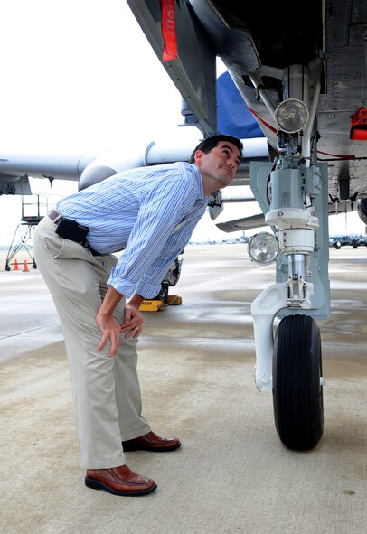 Thomas E. Hamauei, United Title of Louisiana, Inc., attorney branch manager, looks underneath an A-10 Warthog during a static display on the flightline Oct. 13. 2d Bomb Wing hosted a Shreveport Leadership Program tour. The tour consisted of a mission brief and a static display of an A-10 and a B-52H Stratofortress. (U.S. Air Force photo by Senior Airman Alexandra Longfellow) (RELEASED)