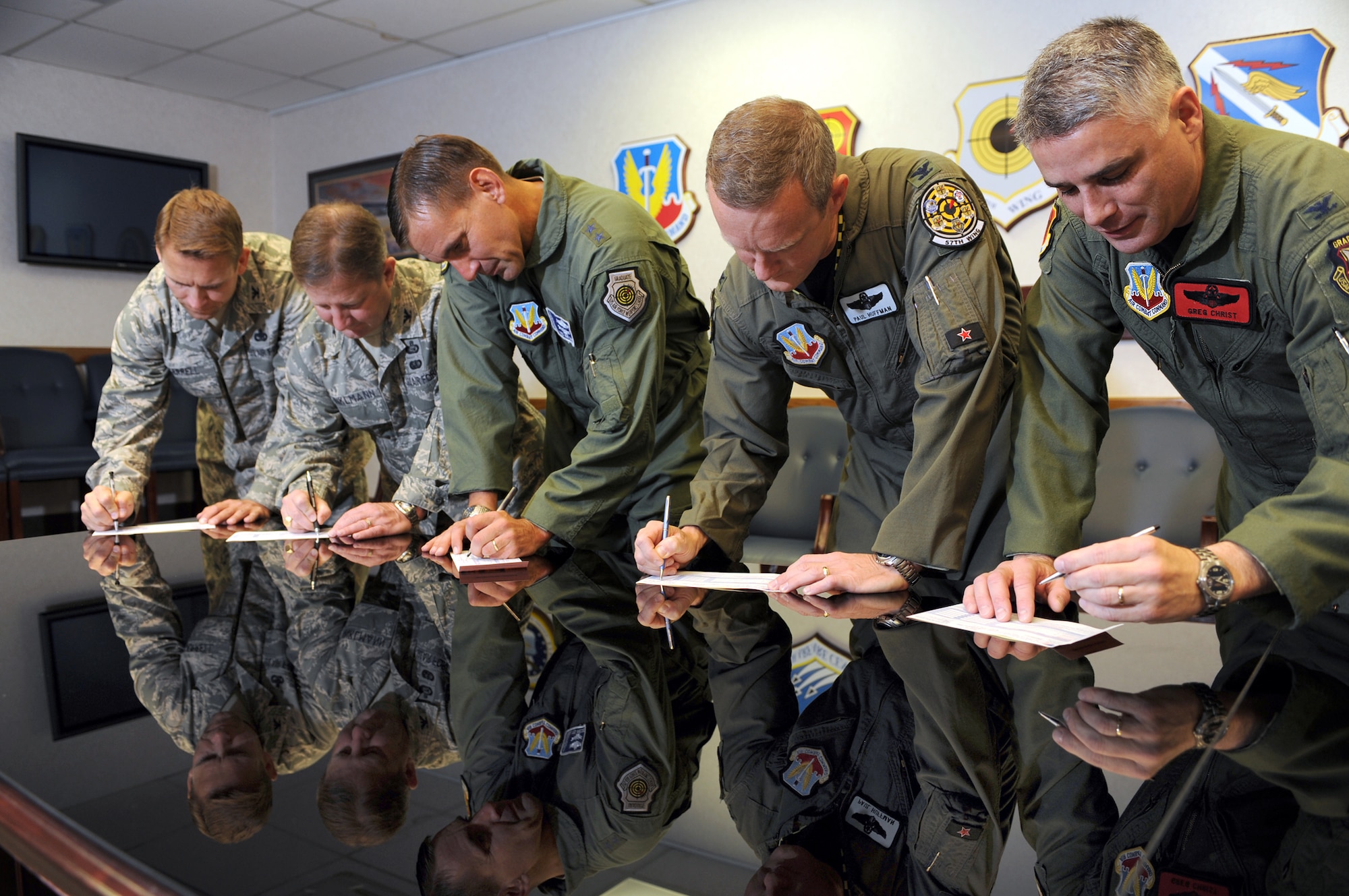 NELLIS AIR FORCE BASE, Nev. -- from left to right, Col. David Carrell, 98th Mission Support Group commander, Col. Steven Winklmann, 99th Air Base Wing vice commander, Maj. Gen. Ted Kresge, United States Air Force Warfare Center commander, Col. Paul Huffman, 57th Wing vice commander, and Col. Greg Christ, 432d Wing vice commander, fill out Combined Federal Campaign contribution forms to kick off the start of the CFC drive at Nellis and Creech Air Force Bases,  Oct. 15. 
(U.S. Air Force photo by Tech Sgt. Michael R. Holzworth)