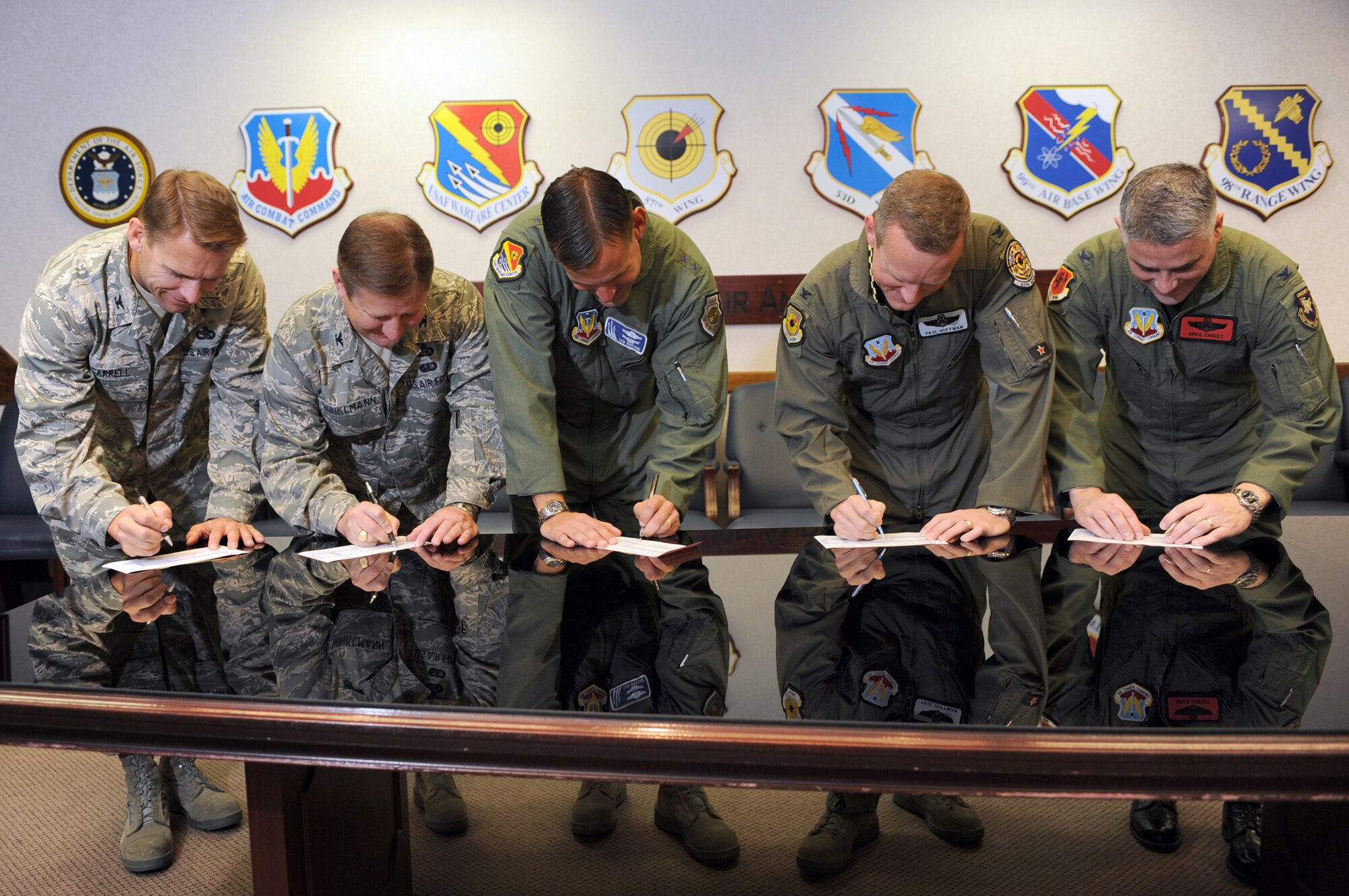 NELLIS AIR FORCE BASE, Nev. -- from left to right, Col. David Carrell, 98th Mission Support Group commander, Col. Steven Winklmann, 99th Air Base Wing vice commander, Maj. Gen. Ted Kresge, United States Air Force Warfare Center commander, Col. Paul Huffman, 57th Wing vice commander, and Col. Greg Christ, 432d Wing vice commander, fill out Combined Federal Campaign contribution forms to kick off the start of the CFC drive at Nellis and Creech Air Force Bases, Oct. 15.  
(U.S. Air Force photo by Tech Sgt. Michael R. Holzworth)