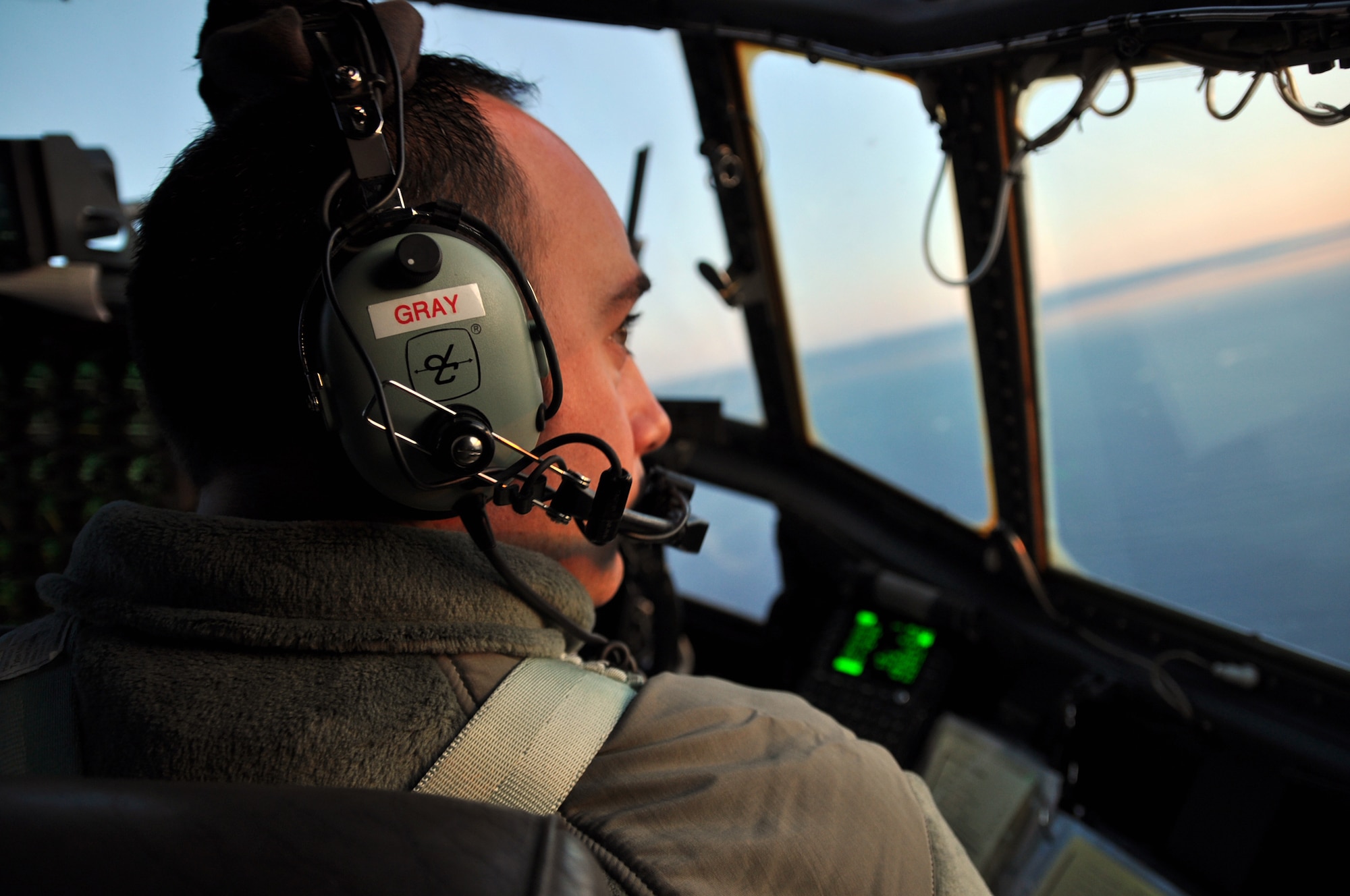 ST. JOHN'S, Newfoundland and Labrador -- Air Force Reservist 1st Lt. Ryan Gray, a pilot with the 773rd Airlift Squadron based at Youngstown Air Reserve Station, Ohio, looks out the cockpit window as the C-130H aircraft he is flying departs the airfield here, Oct. 13, 2009. Lieutenant Gray and the Airmen onboard are headed for Ramstein Air Base, Germany, in support of Operation Joint Enterprise. The Airmen will provide airlift support throughout Europe and Africa. U.S. Air Force photo by Senior Airman Brenda Haines