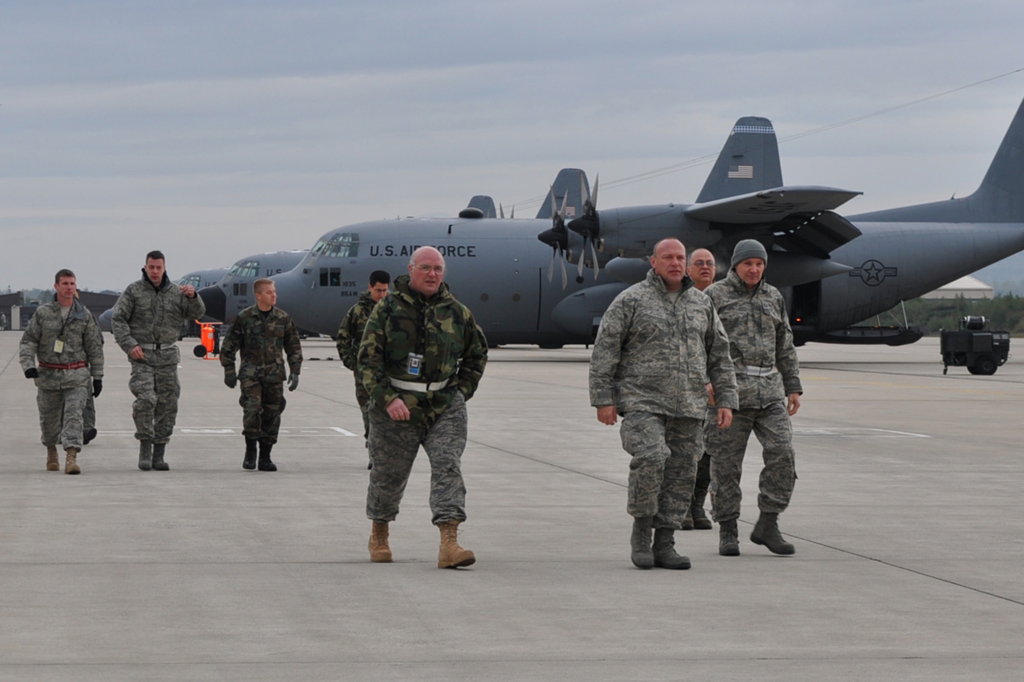 RAMSTEIN AIR BASE, Germany -- Air Force Reservists from Youngstown Air Reserve Station, Ohio, walk towards a C-130H aircraft on the flightline here, Oct. 16, 2009.  The Airmen have completed their mission in support of Operation Joint Enterprise and are going to load onto the aircraft to begin the 2-day trip back to YARS. While deployed at Ramstein, the crews provided airlift support throughout Europe and Affrica. U.S. Air Force photo by Senior Airman Brenda Haines