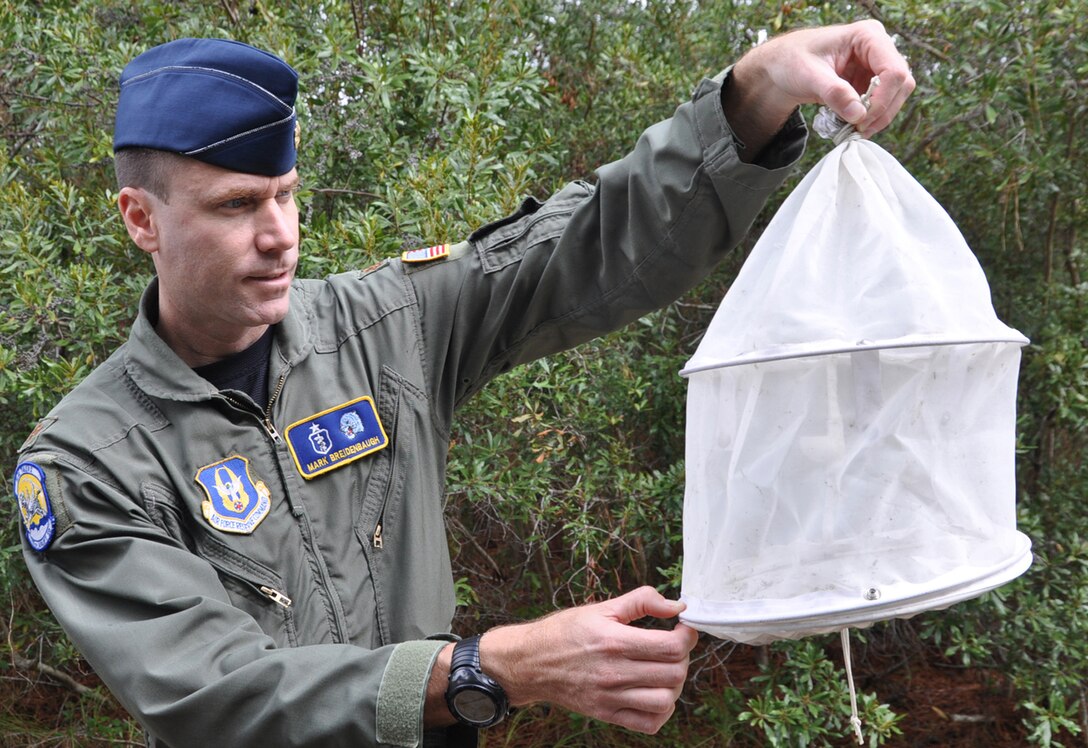 PARRIS ISLAND S.C. — Air Force Reserve Major Mark Breidenbaugh, an entomologist with the 757th Airlift Squadron based at Youngstown Air Reserve Station(YARS), Ohio,  examines an ABC Trap used to gauge the effectiveness of a new environmentally friendly product being used at the Marine Corps Recruit Depot here, October 6. YARS is home to the only large area fixed-wing aerial spray unit in the Department of Defense.  One of their annual missions is to spray biting midges at the depot to provide relief to the Marines. Air Force Photo/Tech. Sgt. Dennis J. Kilker Jr.