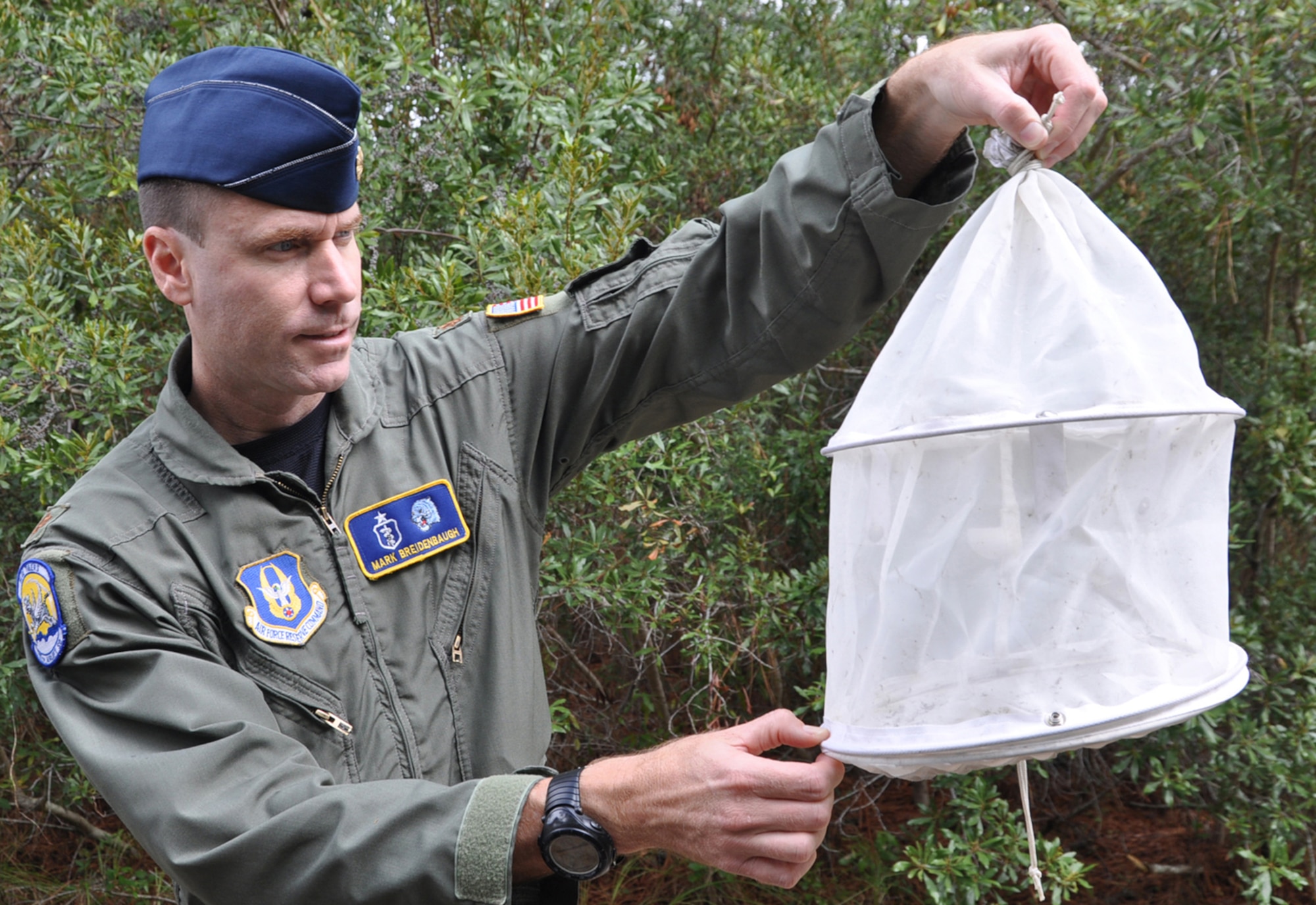 PARRIS ISLAND S.C. — Air Force Reserve Major Mark Breidenbaugh, an entomologist with the 757th Airlift Squadron based at Youngstown Air Reserve Station(YARS), Ohio,  examines an ABC Trap used to gauge the effectiveness of a new environmentally friendly product being used at the Marine Corps Recruit Depot here, October 6. YARS is home to the only large area fixed-wing aerial spray unit in the Department of Defense.  One of their annual missions is to spray biting midges at the depot to provide relief to the Marines. Air Force Photo/Tech. Sgt. Dennis J. Kilker Jr.