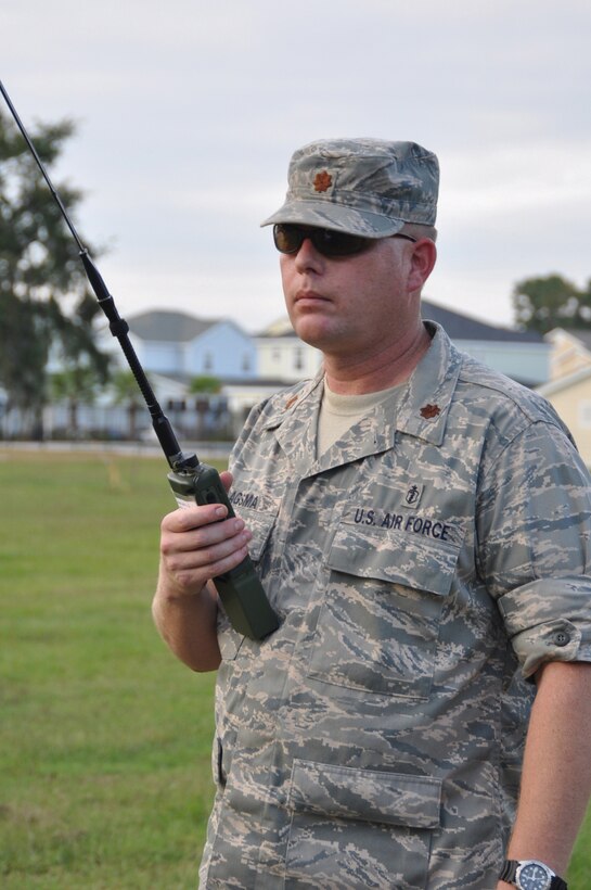 PARRIS ISLAND, S.C. — Air Force Reserve Maj. Karl Haagsma, an entomologist with the 757th Airlift Squadron based at youngstown air Reserve Station, guides in a low flying C-130 Hercules aircraft as its crew prepares to spray for insects here, October 6.  The specially-equipped aircraft applied a new environmentally friendly product to give the Marines here relief from biting midges and mosquitoes. The specially outfitted aerial spray aircraft distributes the insecticide from 150 feet off the ground to ensure maximum coverage of the target area. U.S. Air Force Photo/Tech Sgt. Dennis J. Kilker Jr.