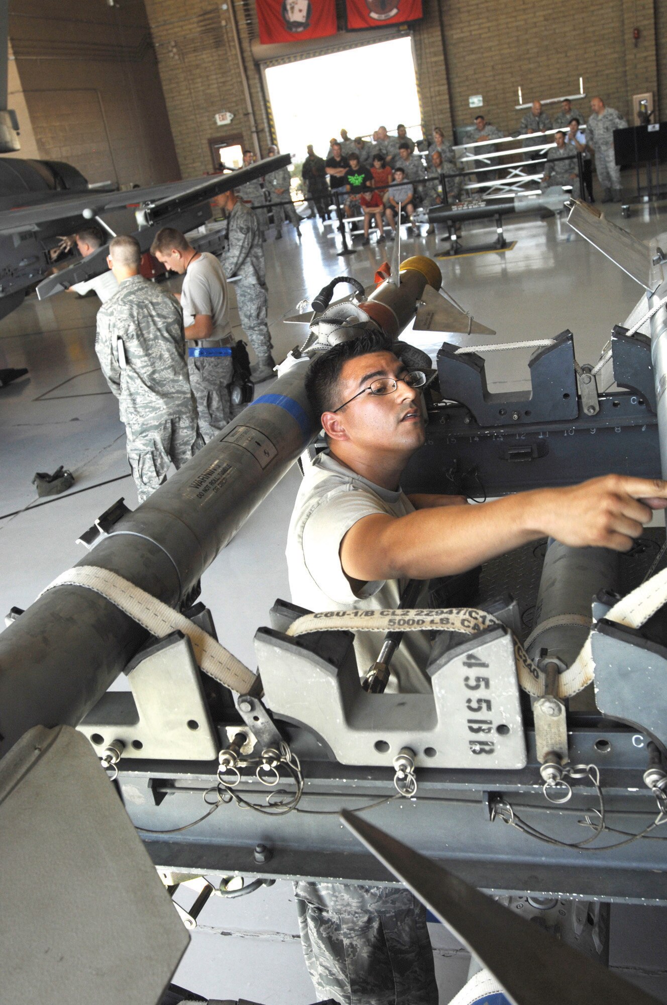 Airman Enrique Melgarejo, 309th Aircraft Maintenance Unit air ground equipment apprentice, prepares munitions for placement onto an F-16 during the competition, Oct. 9 at Luke Air Force Base, Ariz. (U.S. Air Force photo by Staff. Sgt. Gary Mathieson)