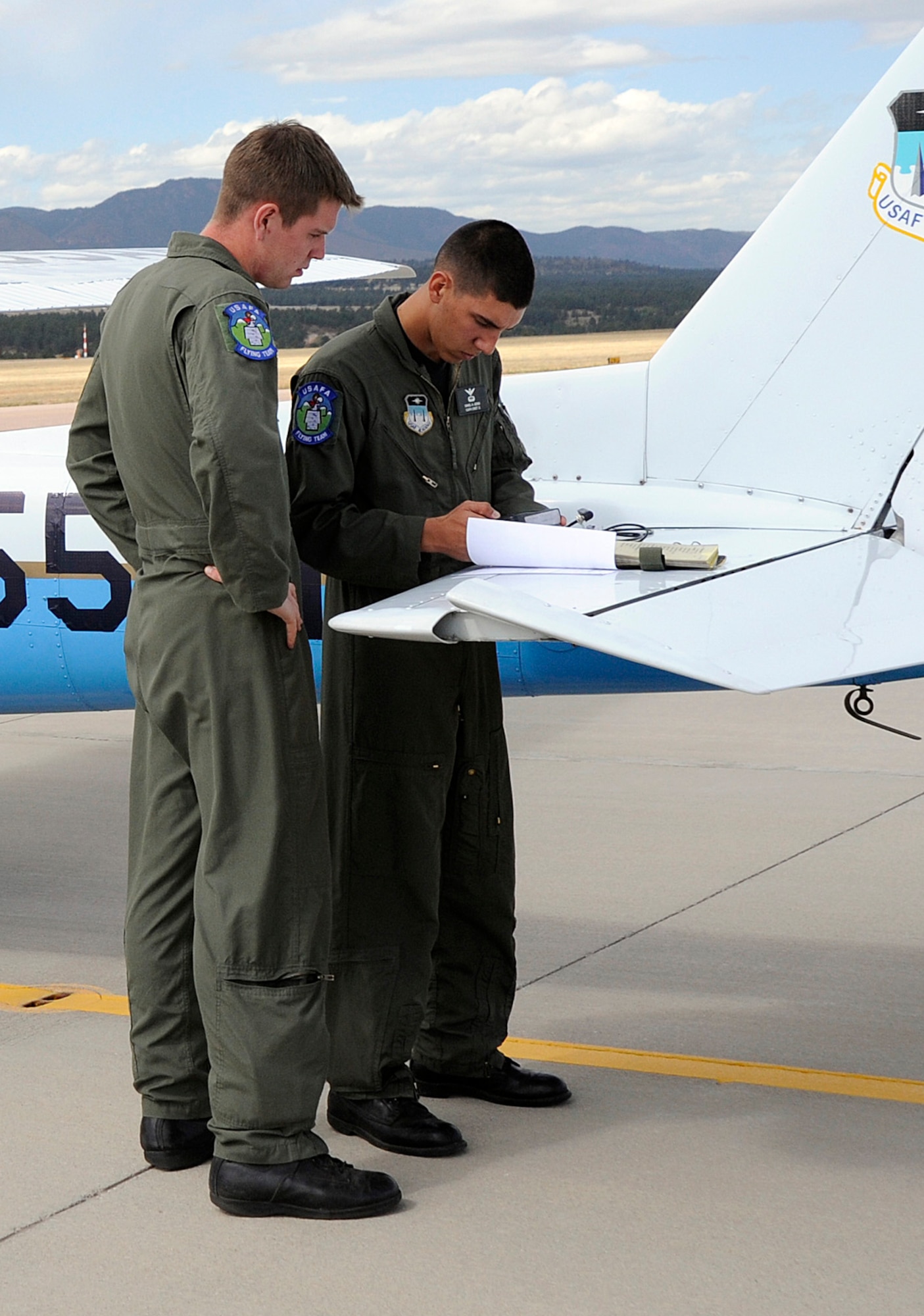 Cadet 1st Class John Rice and Cadet 2nd Class Daniel Gidasi make final preparations before a navigation competition as part of the National Intercollegiate Flying Association District I Safety and Flight Evaluation Conference at the Air Force Academy in Colorado Springs, Colo., Oct. 7, 2009. The Academy took first place in the competition, which ran Oct. 3-11. (U.S. Air Force photo/Rachel Boettcher)